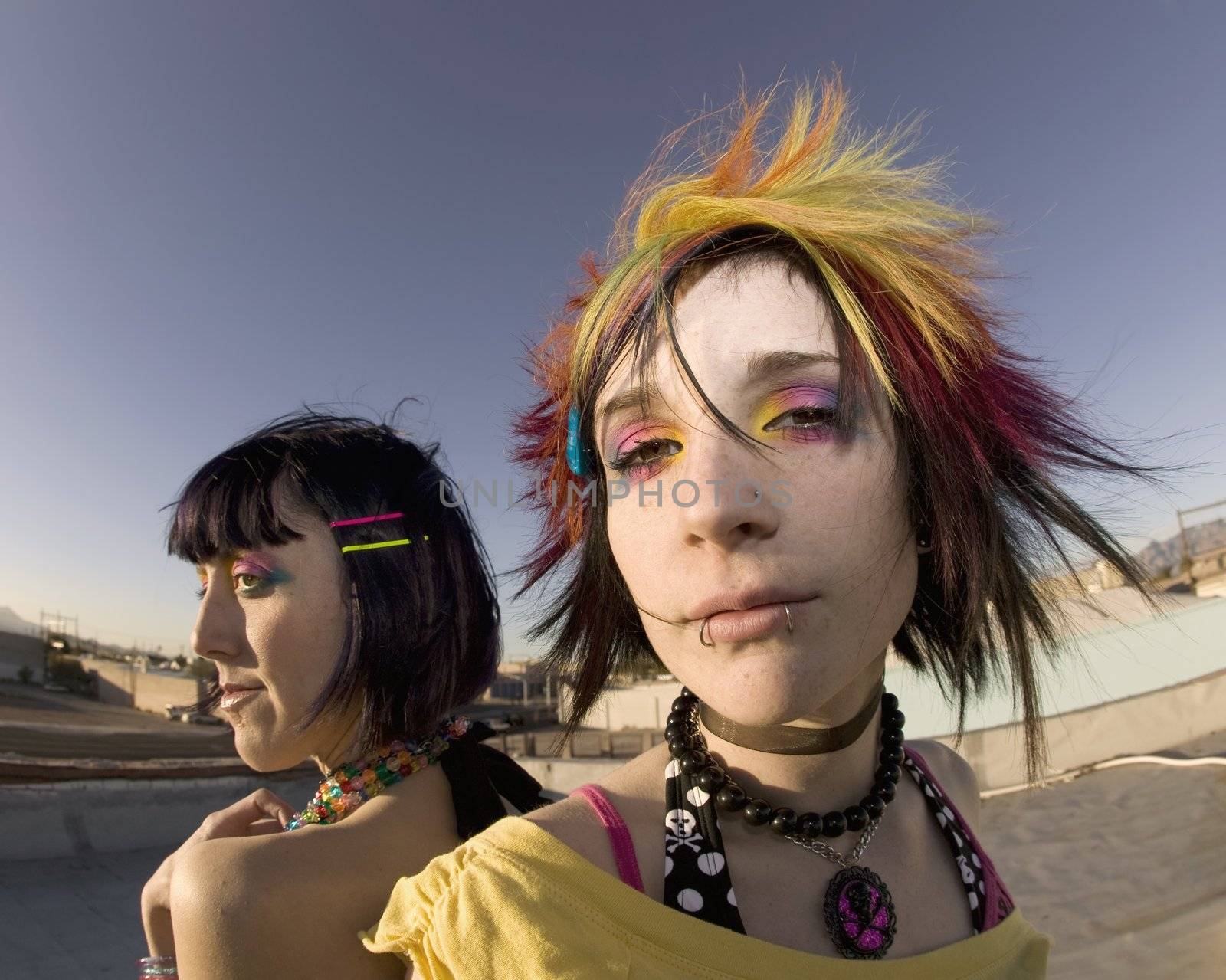 Fisheye shot of girls in brightly colored clothing on a roof
