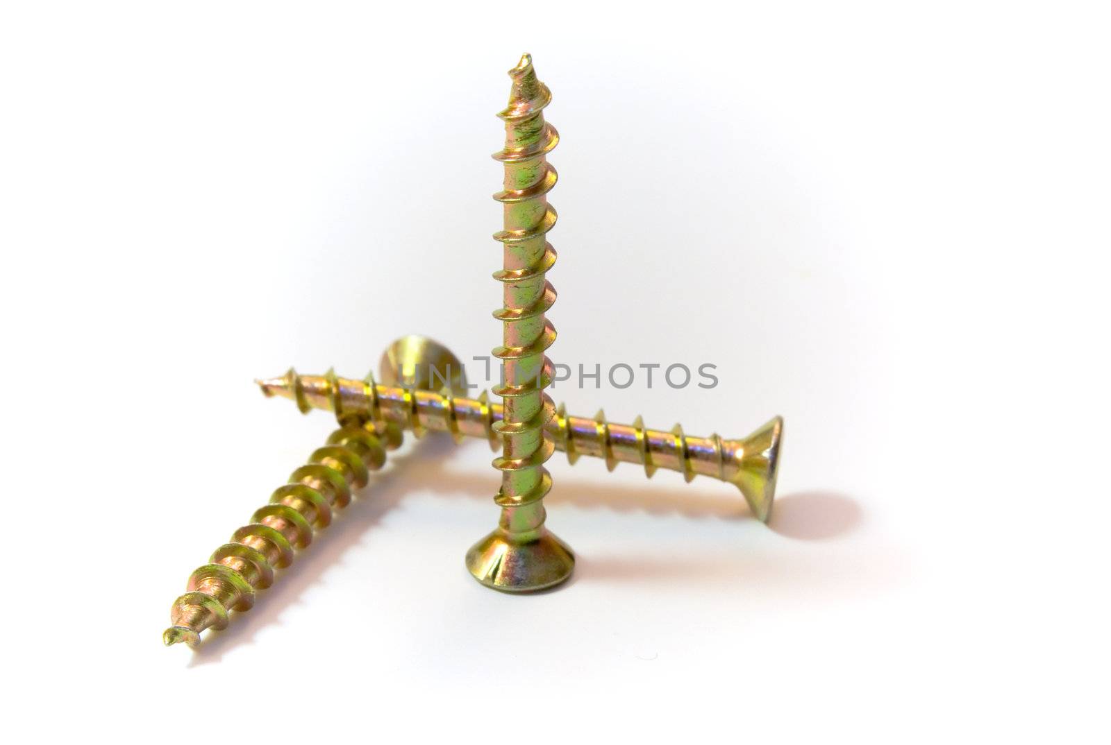Three zinced screws, are photographed on a white background
