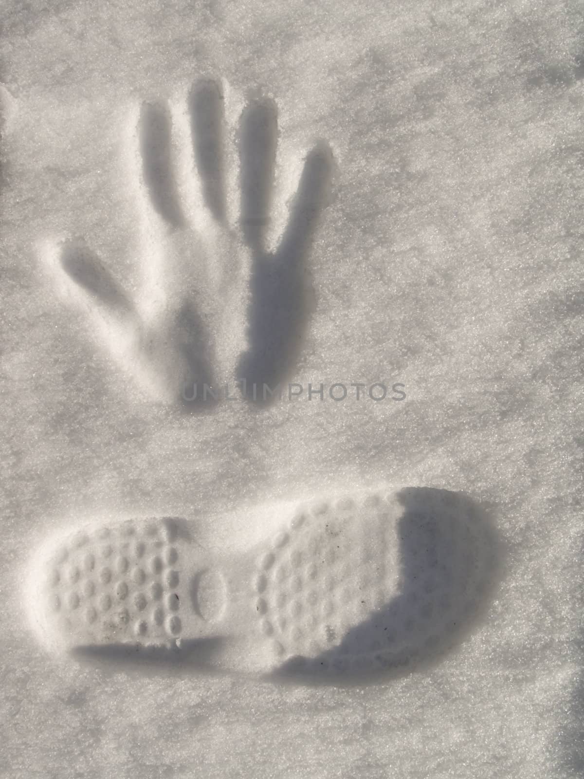 Snow  imprint of human hand and foot