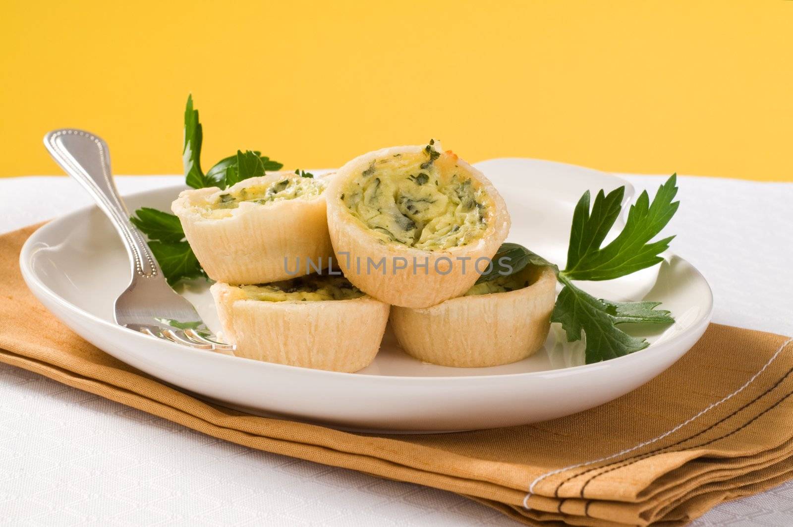 Delicious homemade mini quiche on a plate.