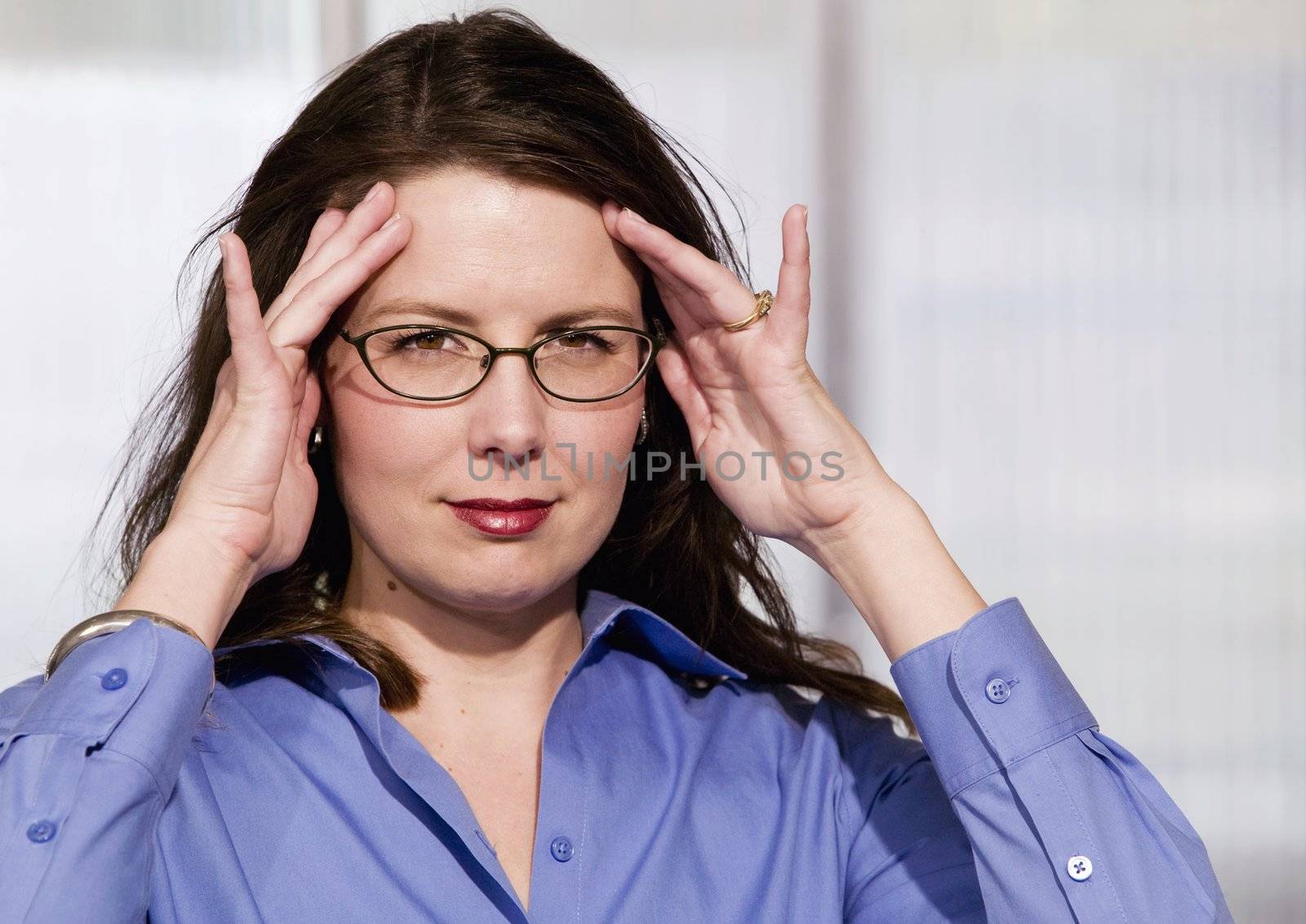 Mildly Frustrated Business Woman with her Hands at her Temples