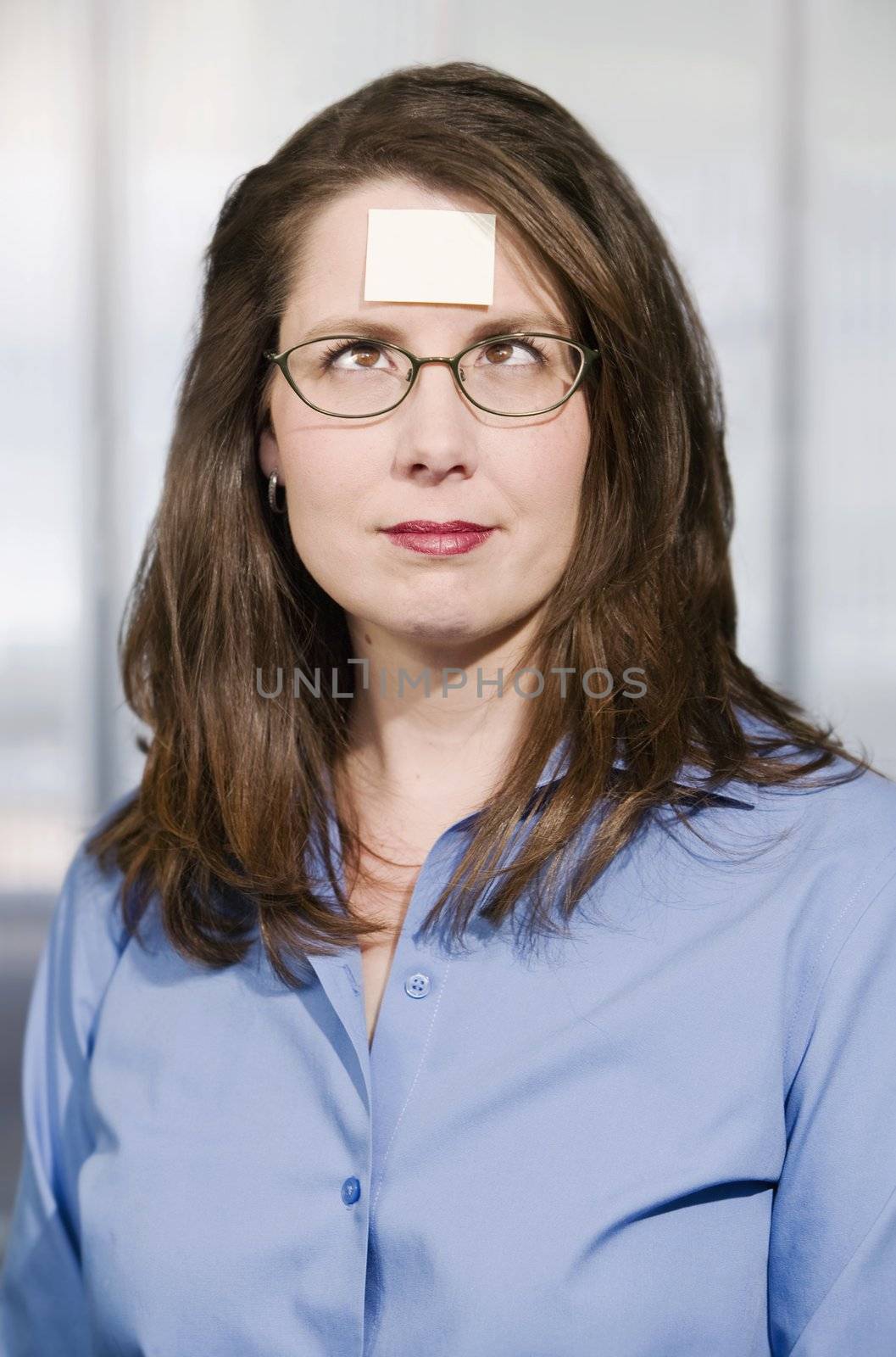 Businesswoman with a blank note on her forehead by Creatista