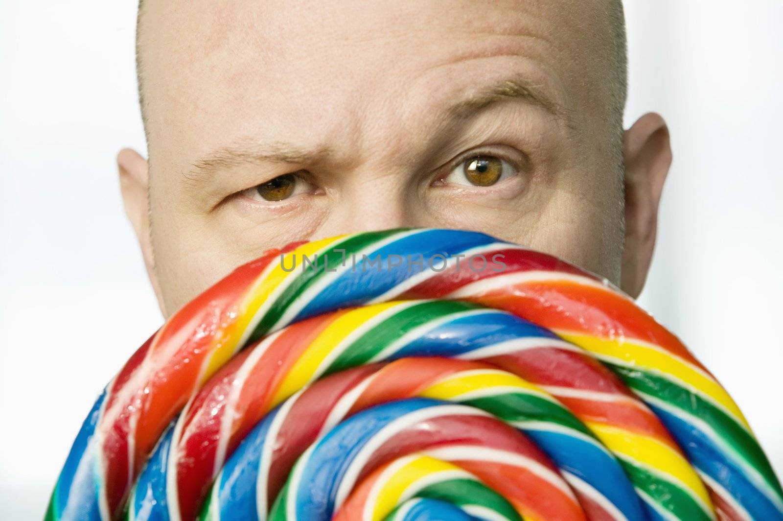 Man Peeking Out From Behind A Lollipop by Creatista