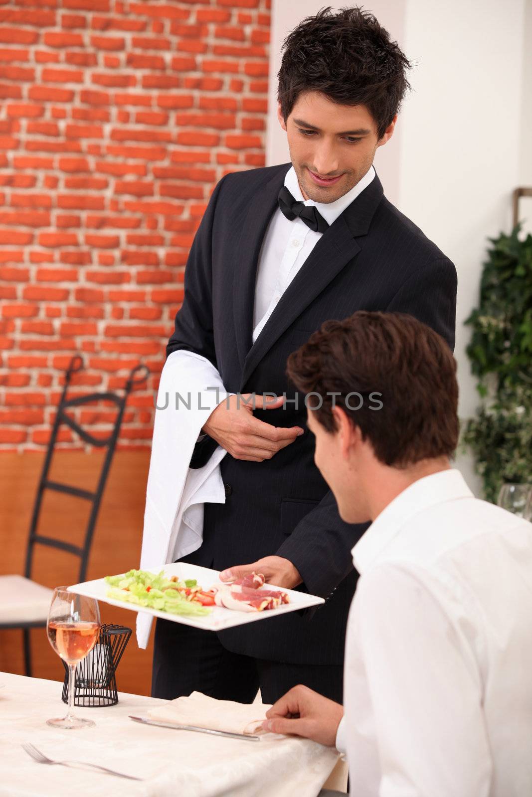 Smart waiter in restaurant by phovoir
