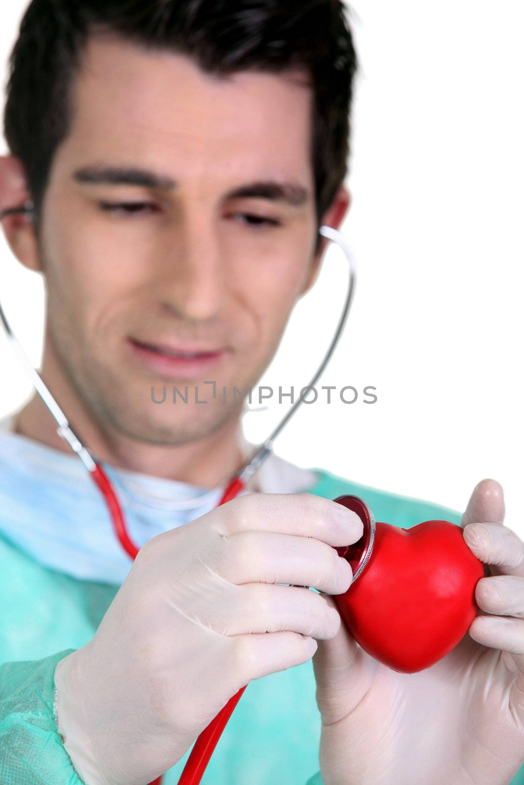 Doctor listening to the heartbeat of a heart by phovoir