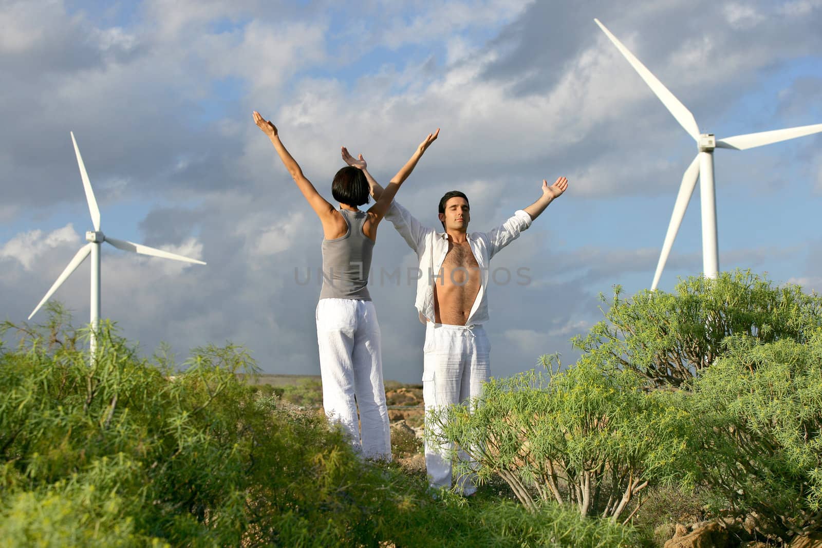 Couple stood in wind farm by phovoir