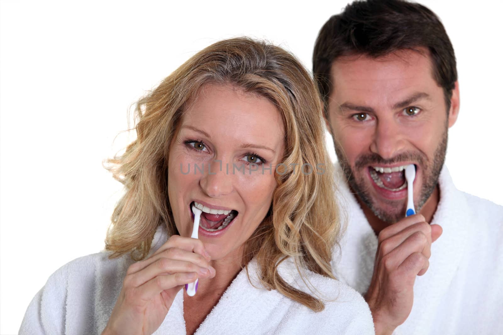 woman and man brushing teeth by phovoir