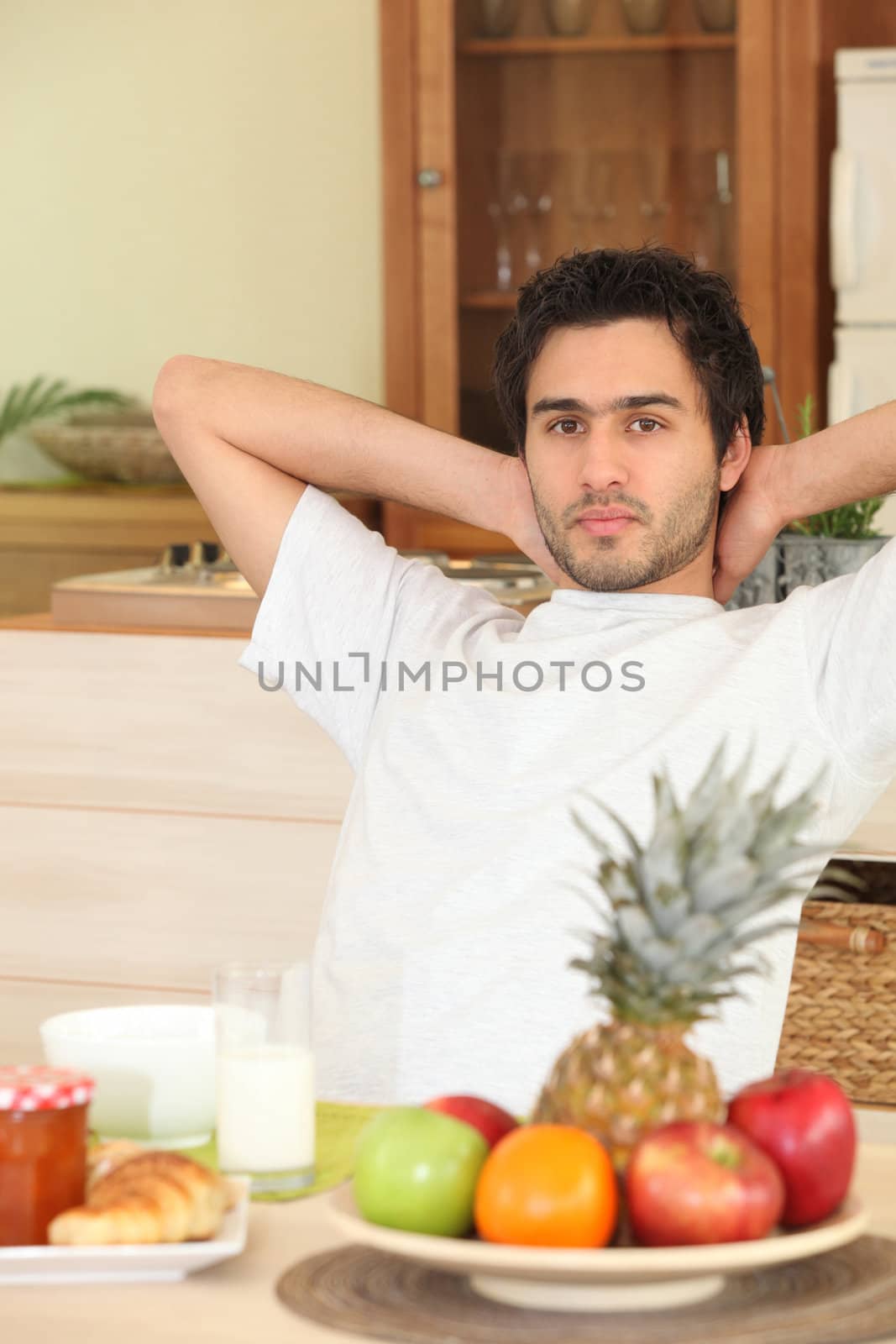 Man relaxing in kitchen by phovoir