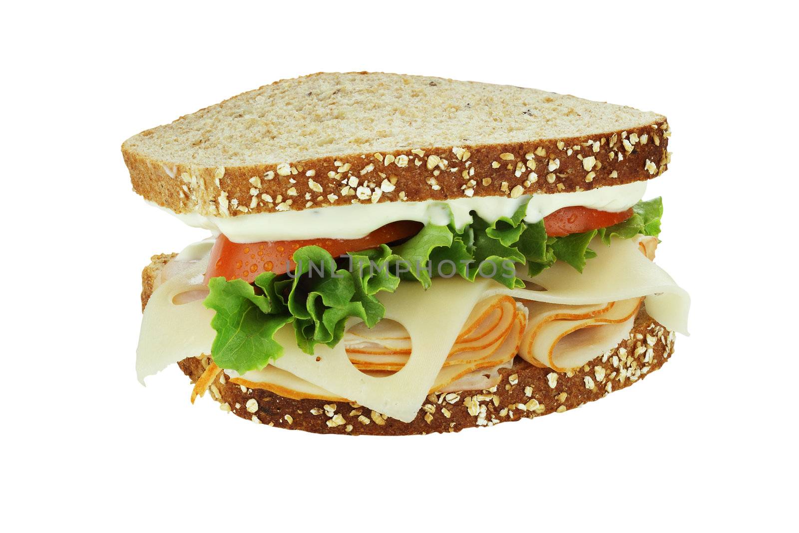 Smoked chicken sandwich with lettuce, tomato and swiss cheese on whole grain bread isolated on a white background. Clipping path included.

