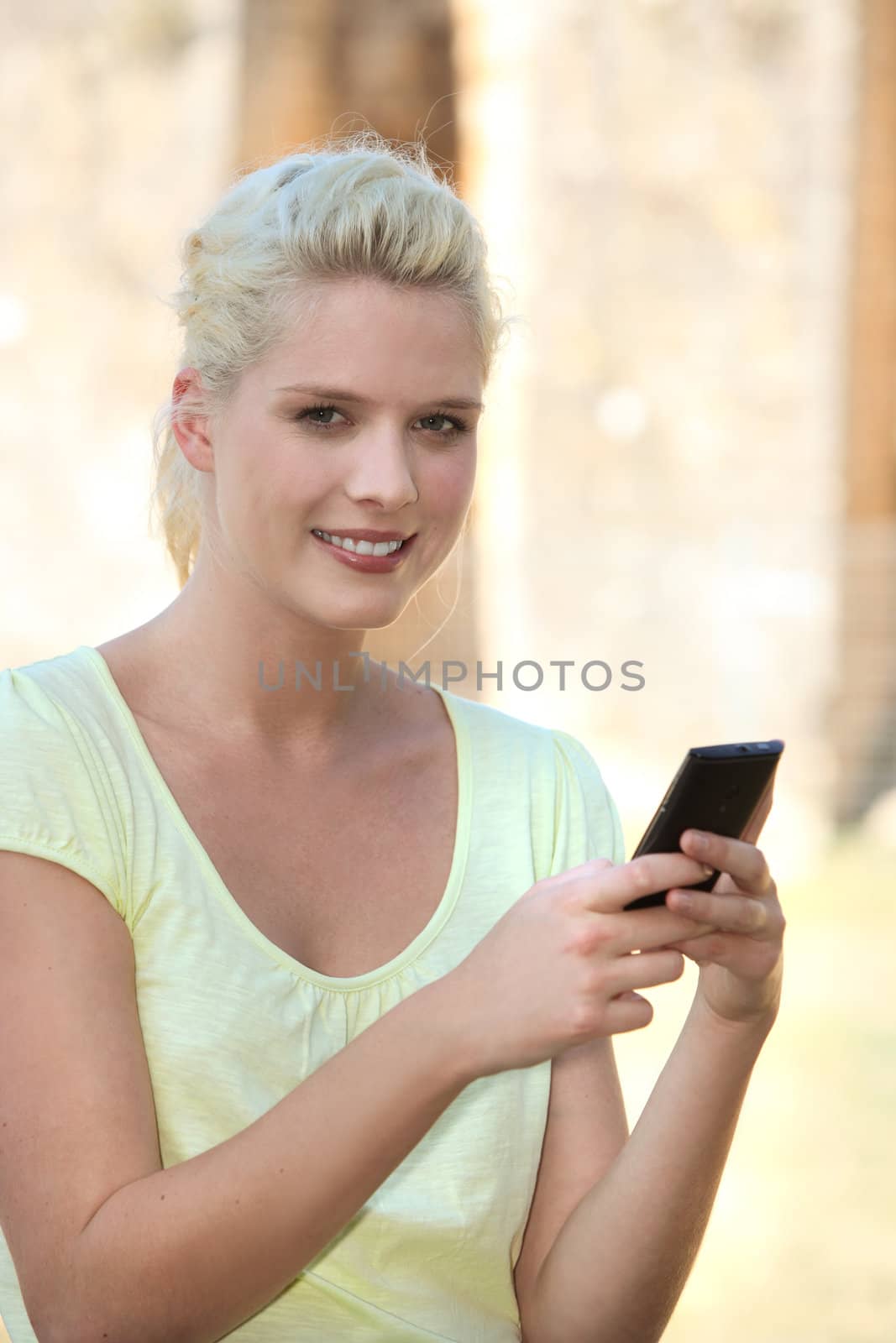 Woman sending a text message by phovoir
