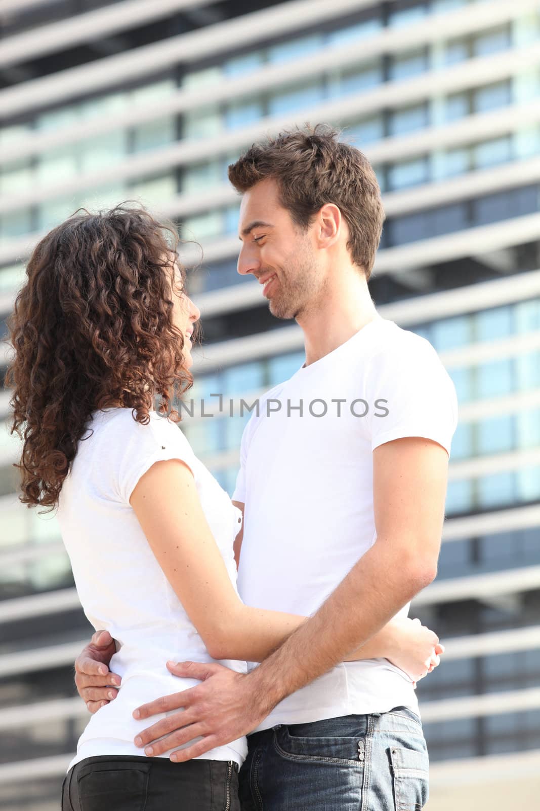 Couple hugging in the city by phovoir