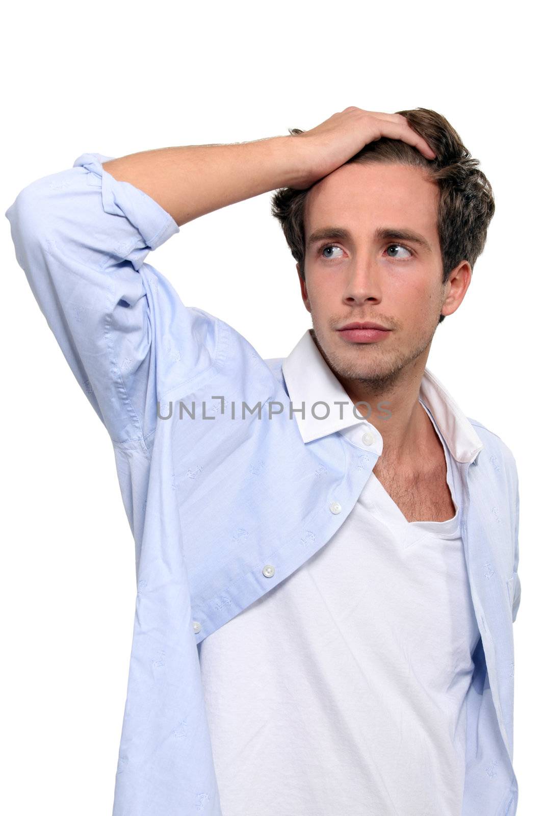 Young man running his hand through his hair by phovoir