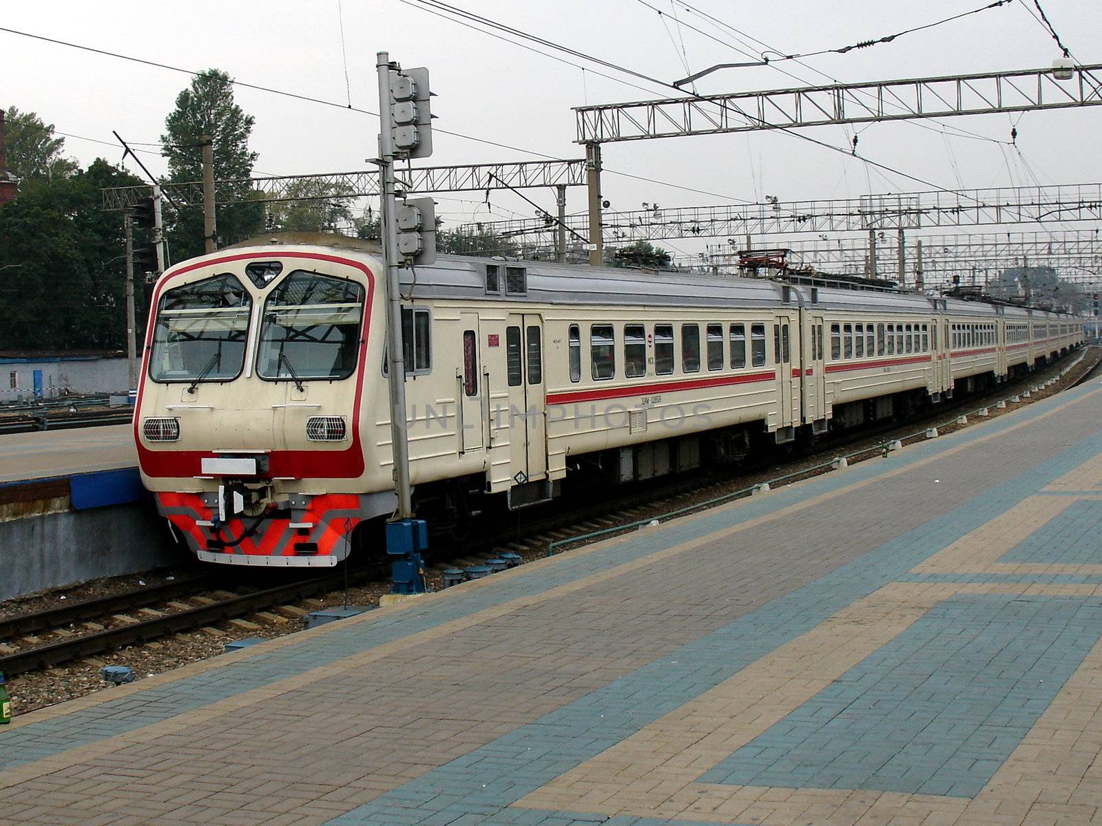 Rapid locomotive train with passengers at the station