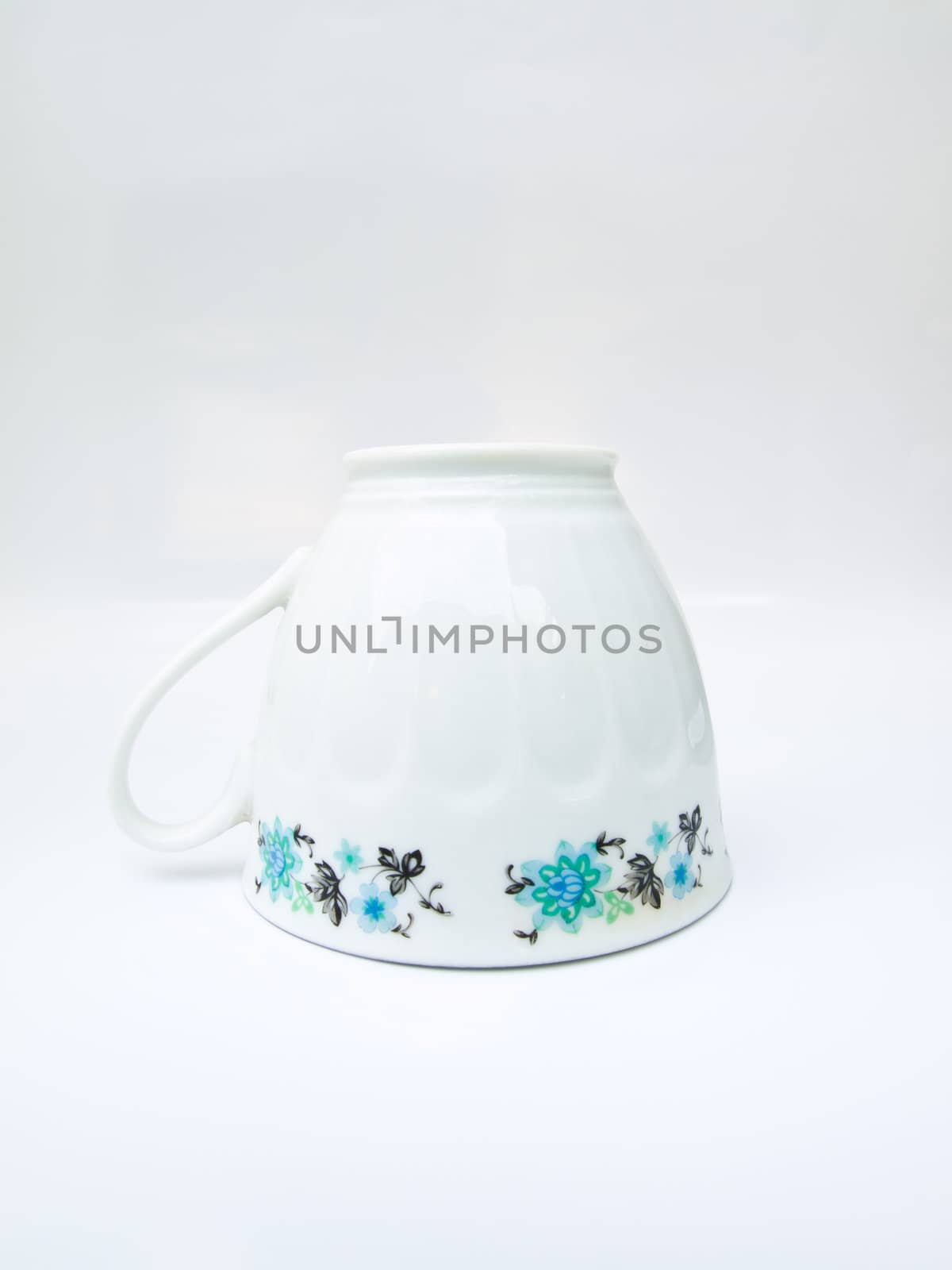 A floral pattern tea cup isolated on white background by gururugu