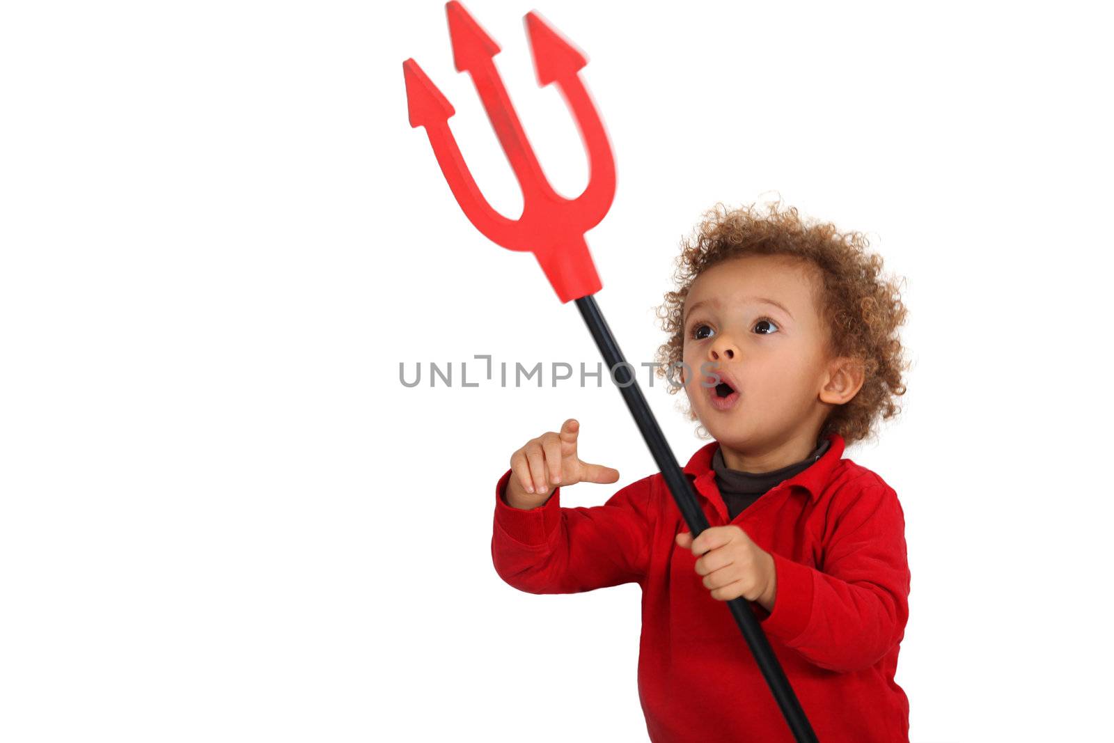 Young child holding up a devil's fork