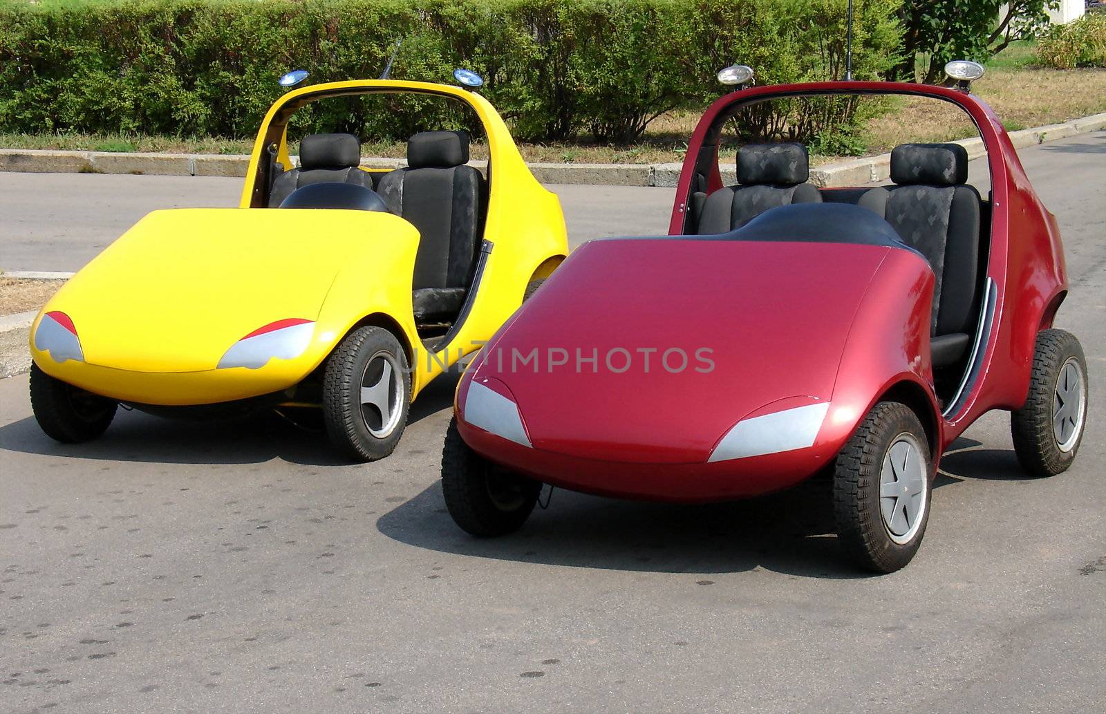Pair of red and yellow child cars