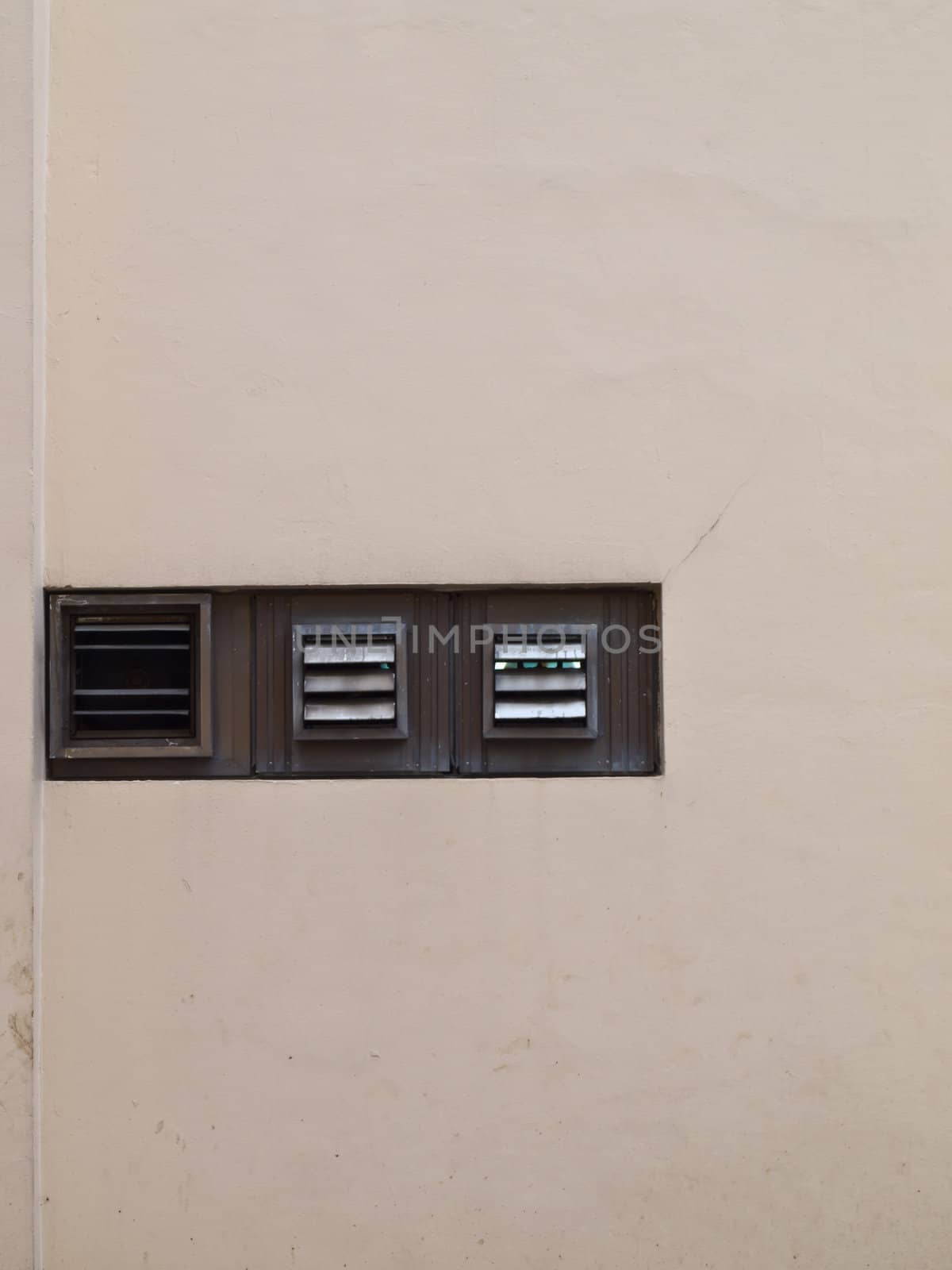 Ventilated windows on wall as background