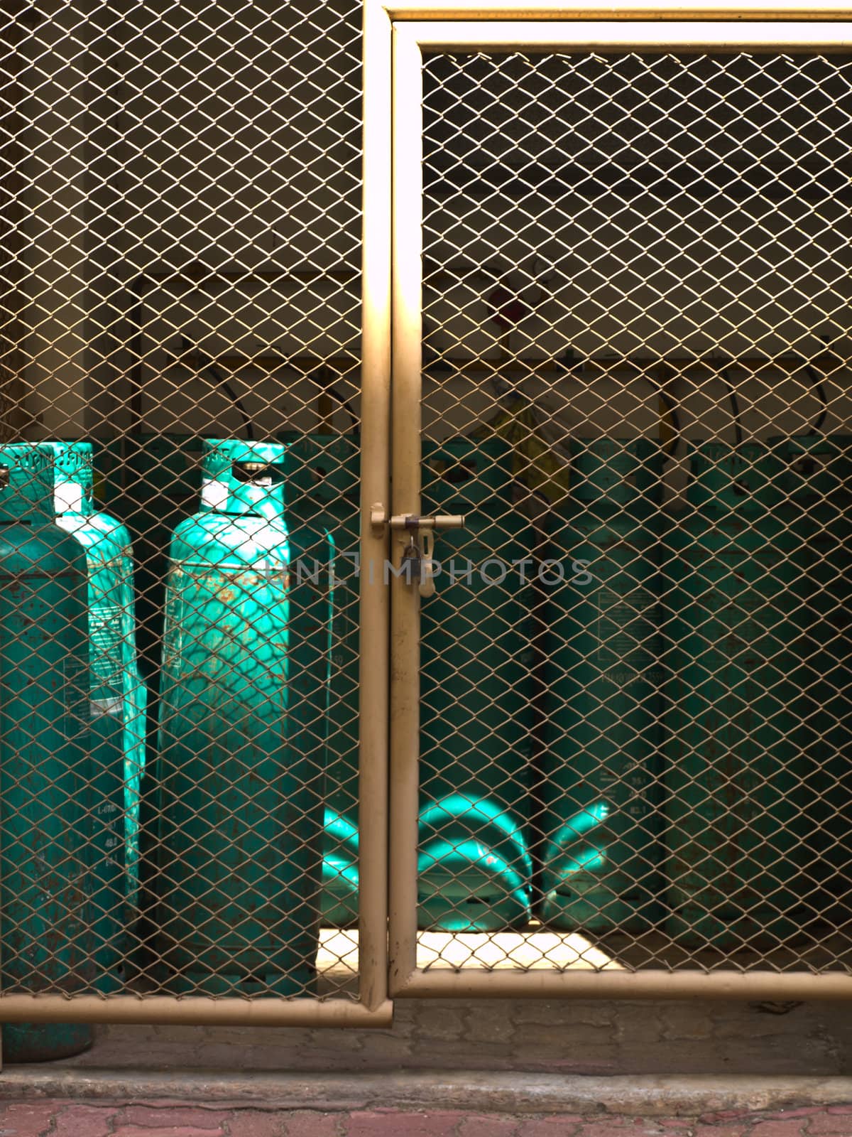 Gas bottles in a row behind a fence for background use
