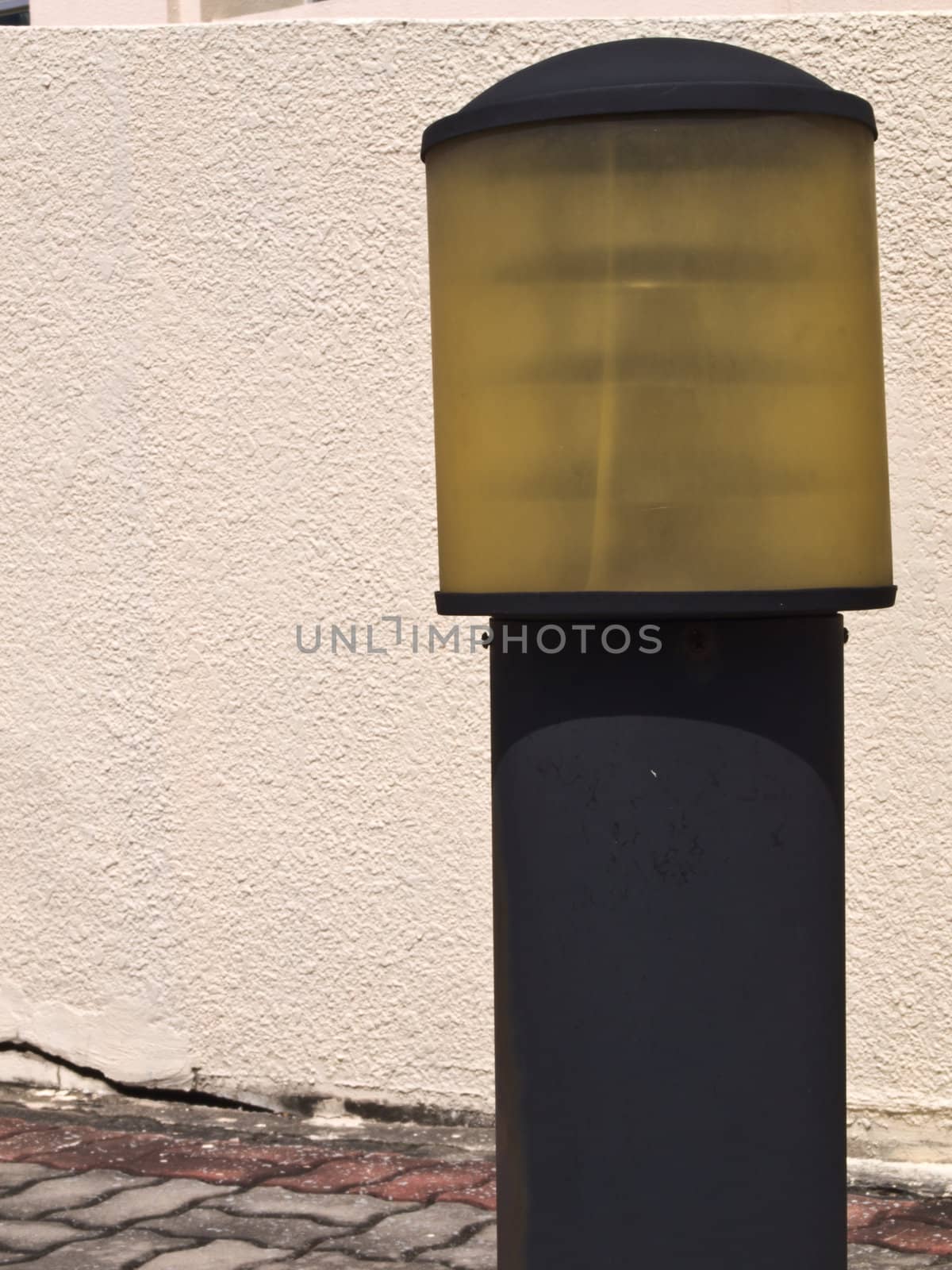 Old lamp pole on white wall