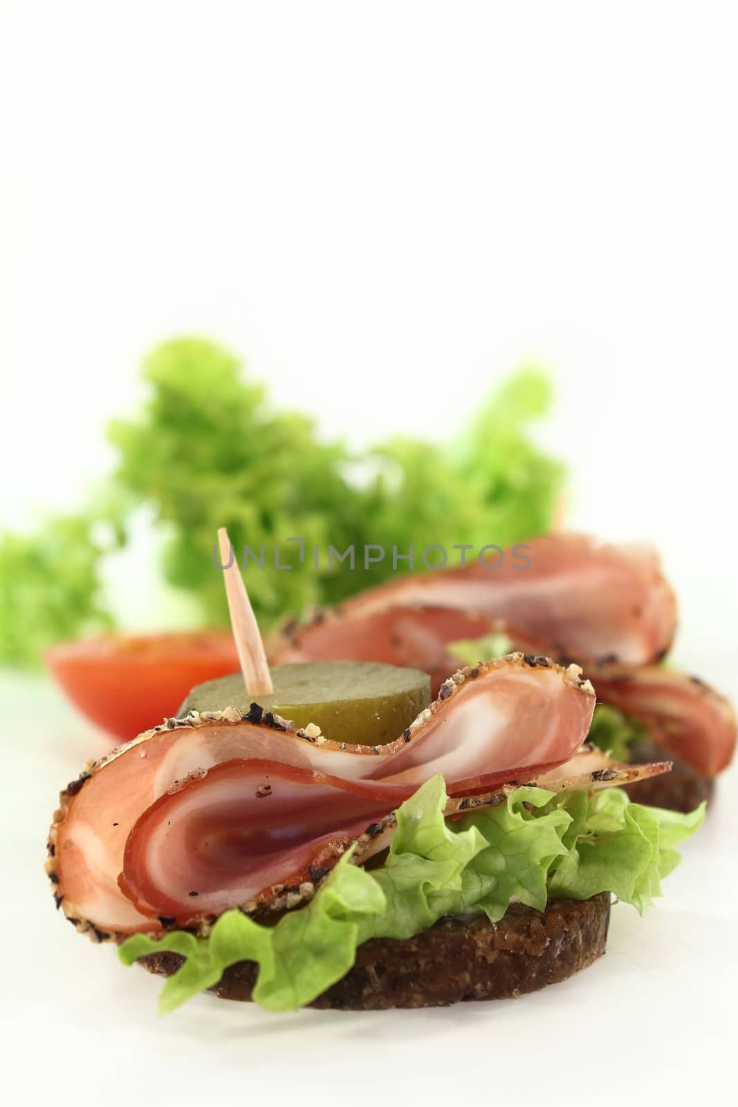 Canapes with smoked bacon and sour cucumber