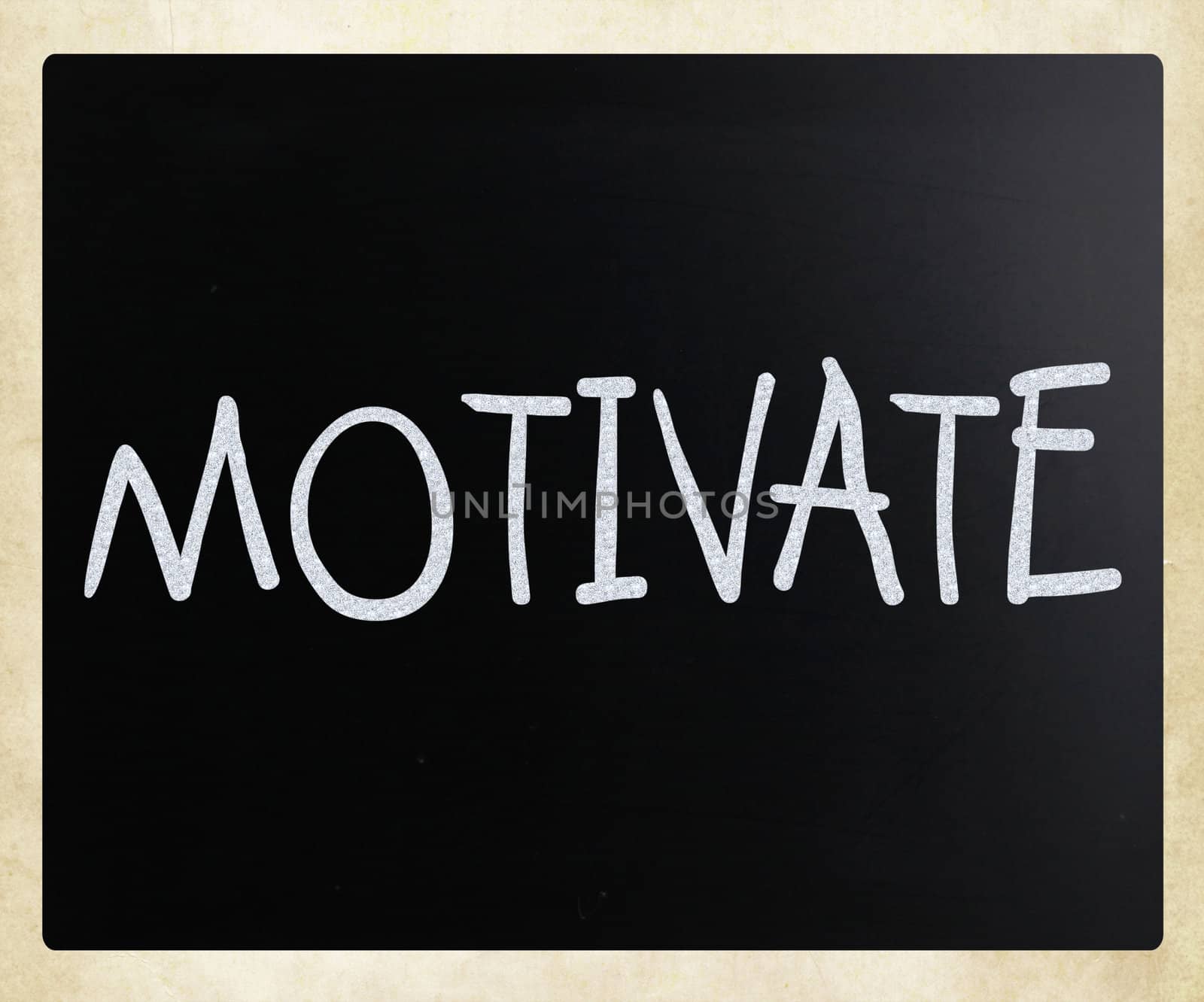 "Motivate" handwritten with white chalk on a blackboard