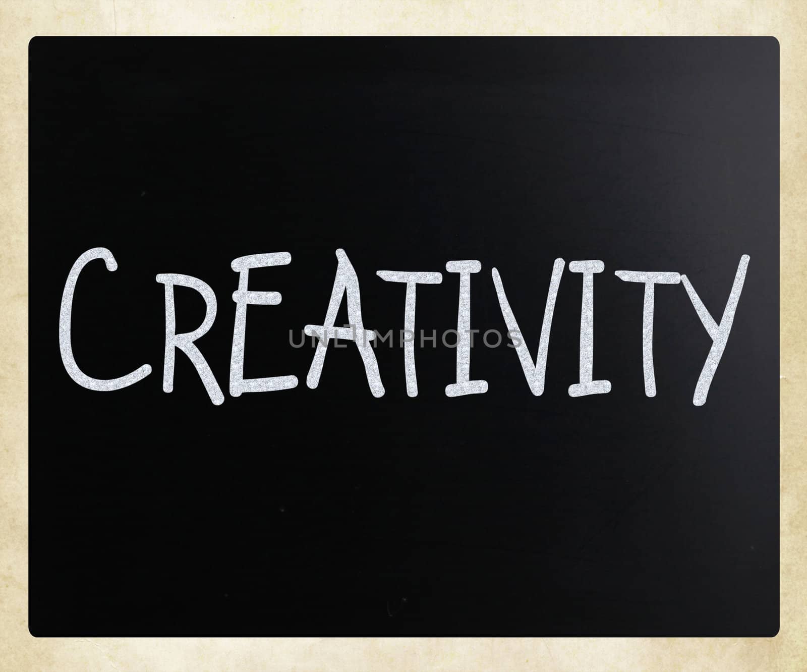 The word "Creativity" handwritten with white chalk on a blackboard