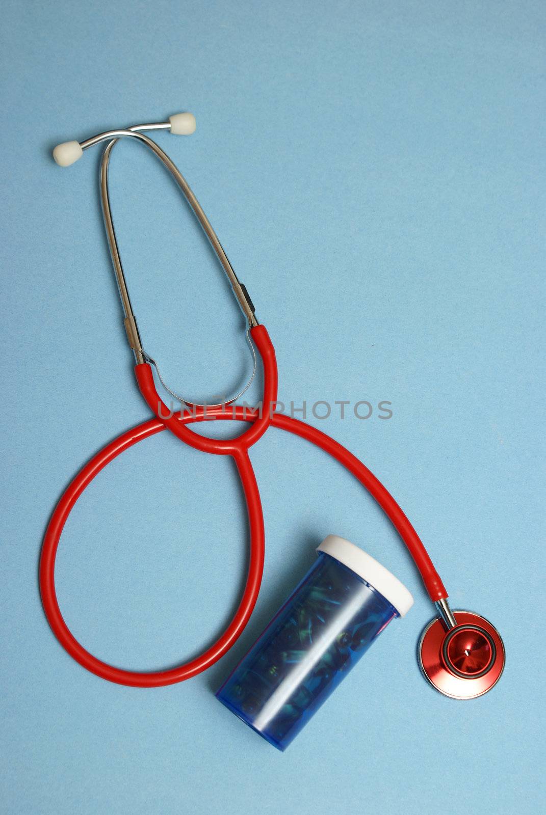 A stethoscope and pill bottle to remedy many medical treatments for the patient.