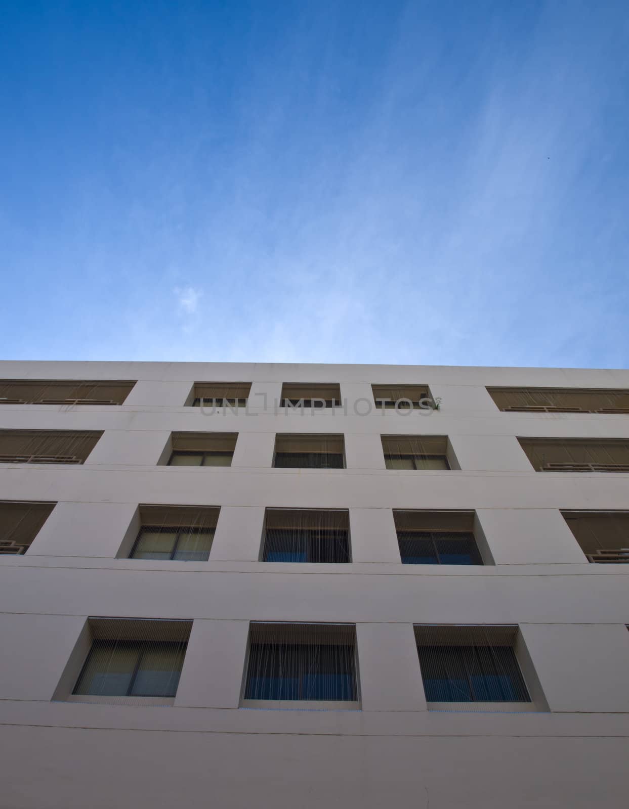 Facade windows of office building on blue sky