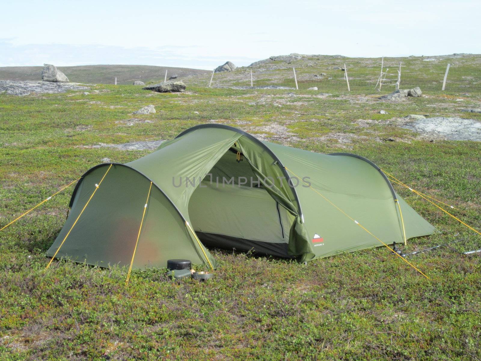 Camping tent in barren landscape.