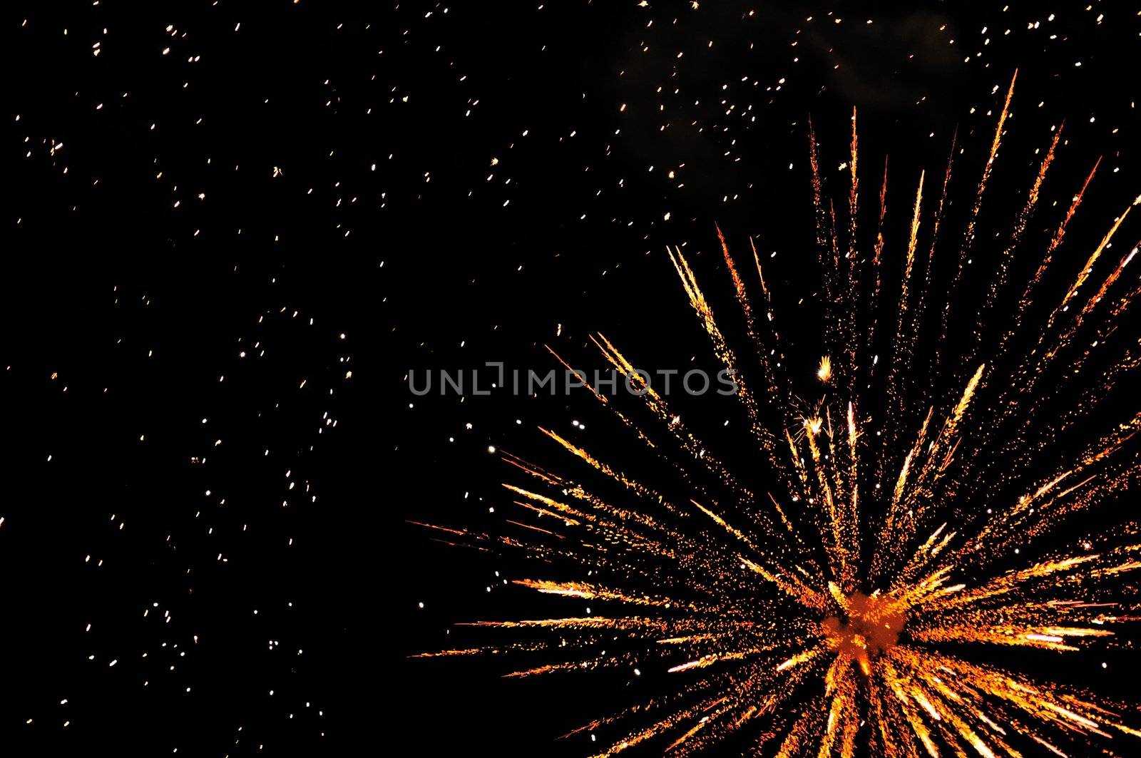 Golden festive fireworks in colorful shades of yellow and orange