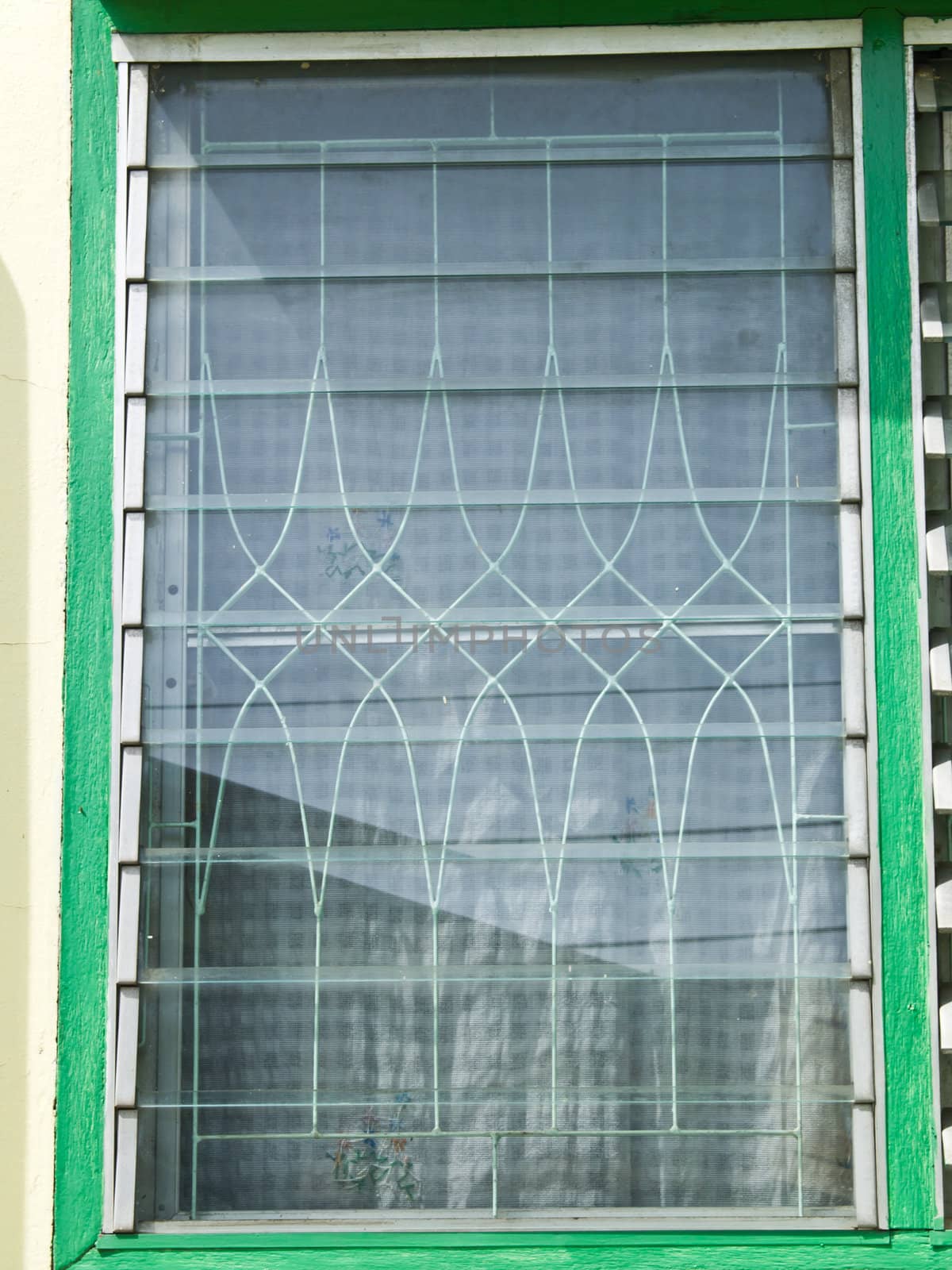 A closed glass lourve window