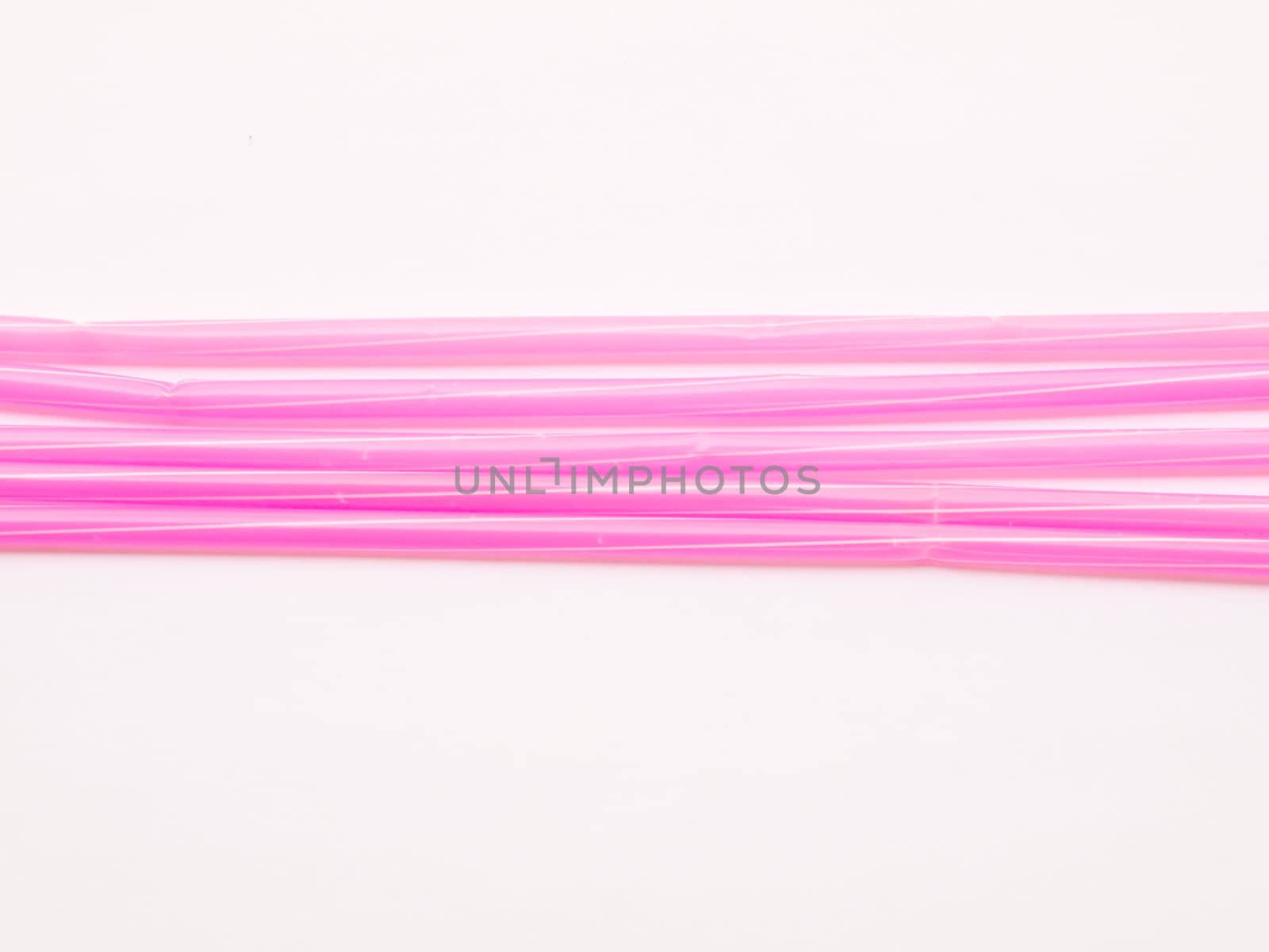 Pink straws isolated on white background