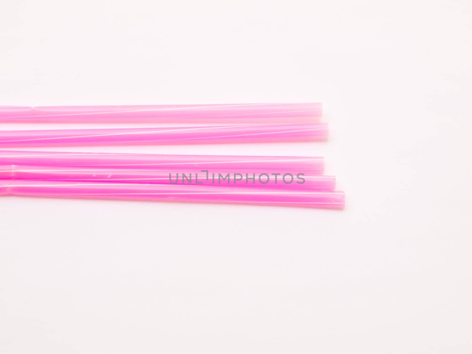 Pink straws isolated on white background