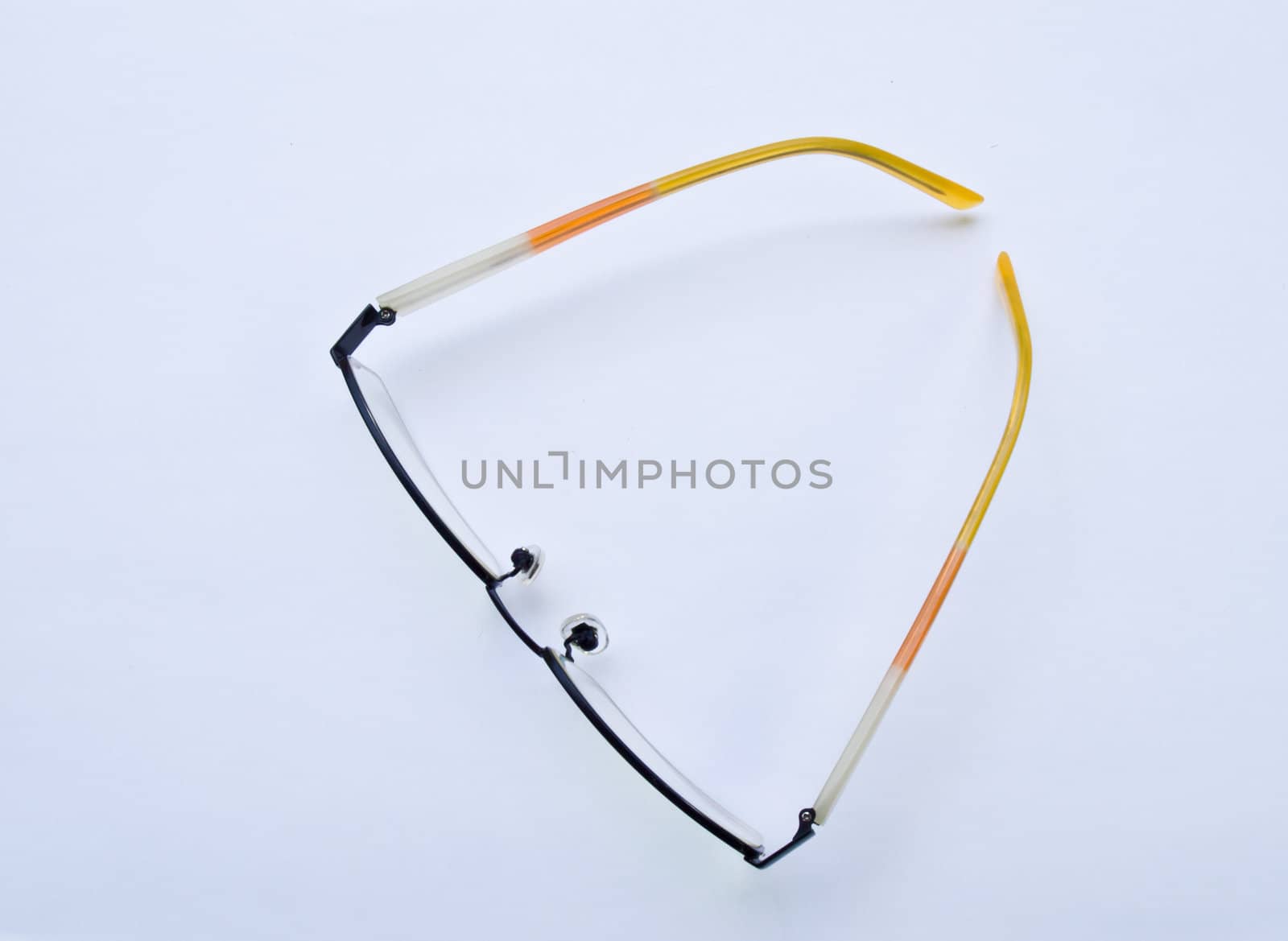 Yellow glasses isolated on white background topview