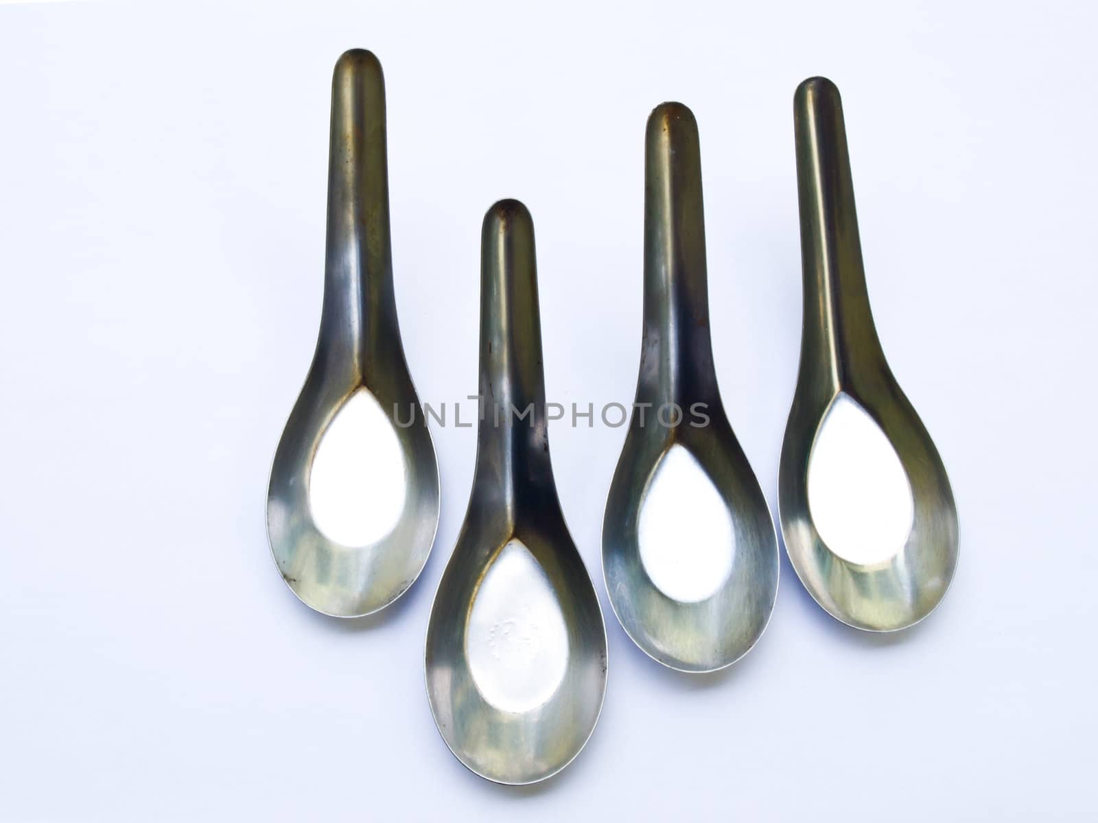 Used stainless stell spoons isolated on white background