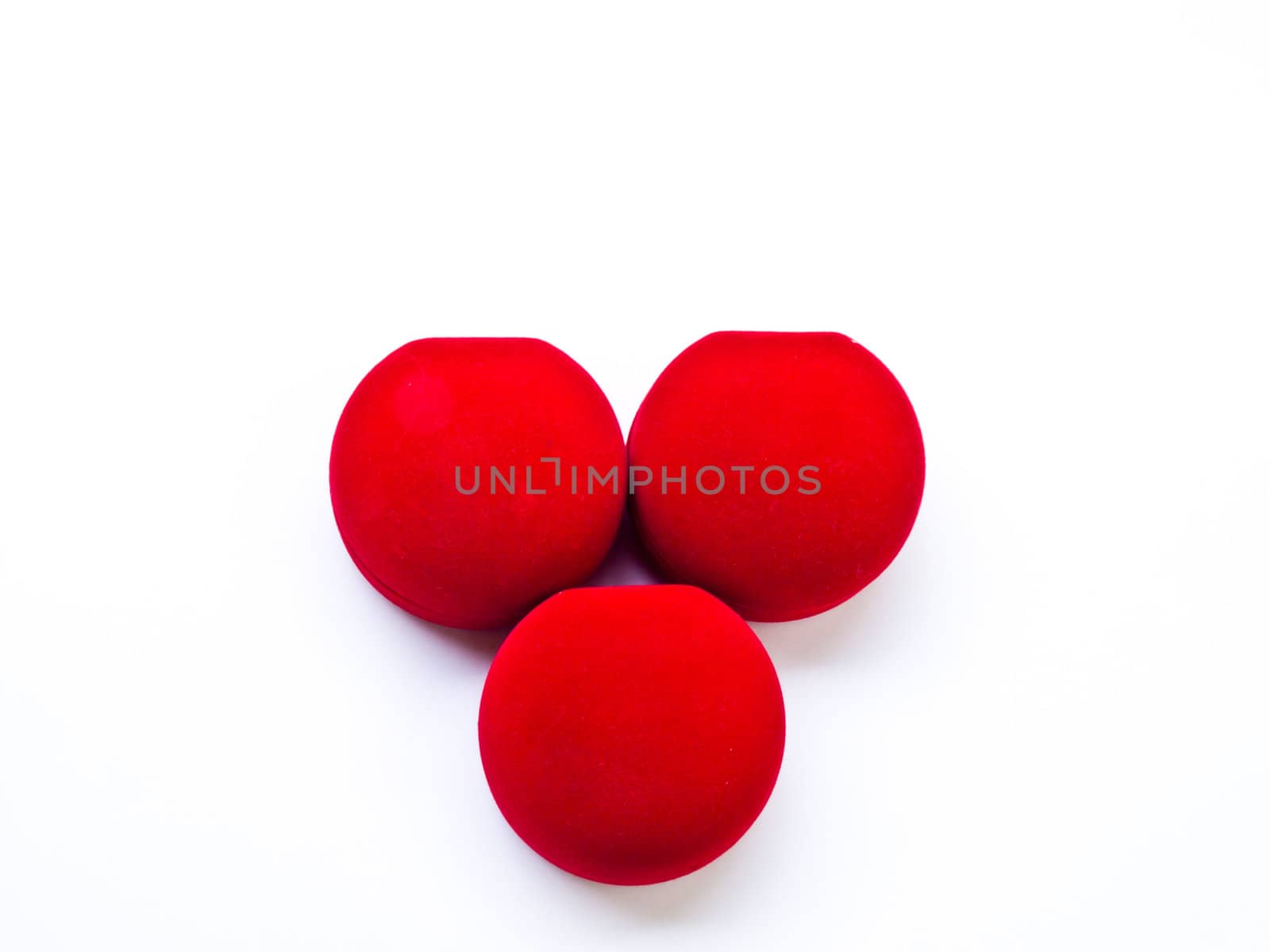 Closed round red jewelry boxes isolated on white background by gururugu
