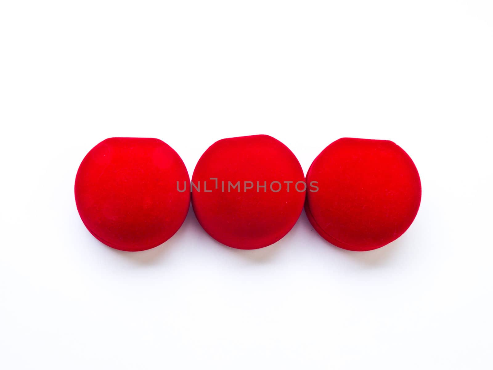 Closed round red jewelry boxes isolated on white background by gururugu
