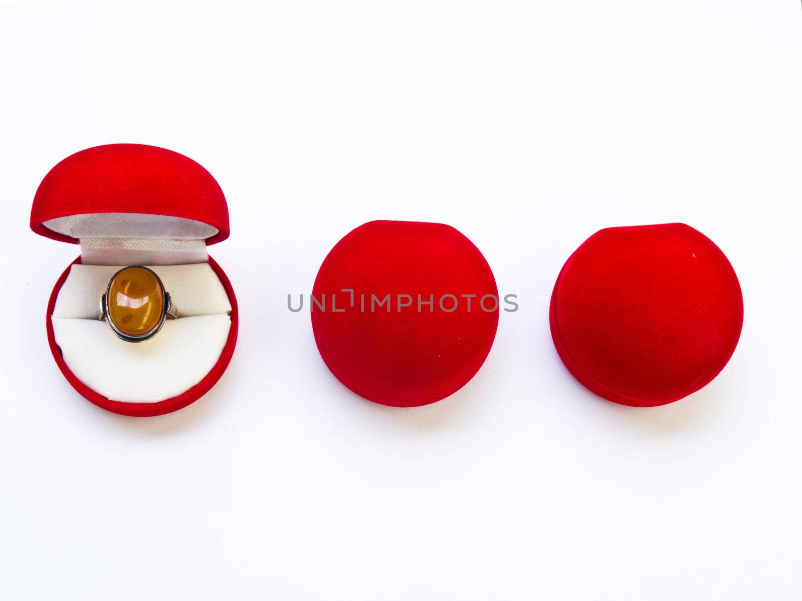 Opened round red jewelry boxes isolated on white background