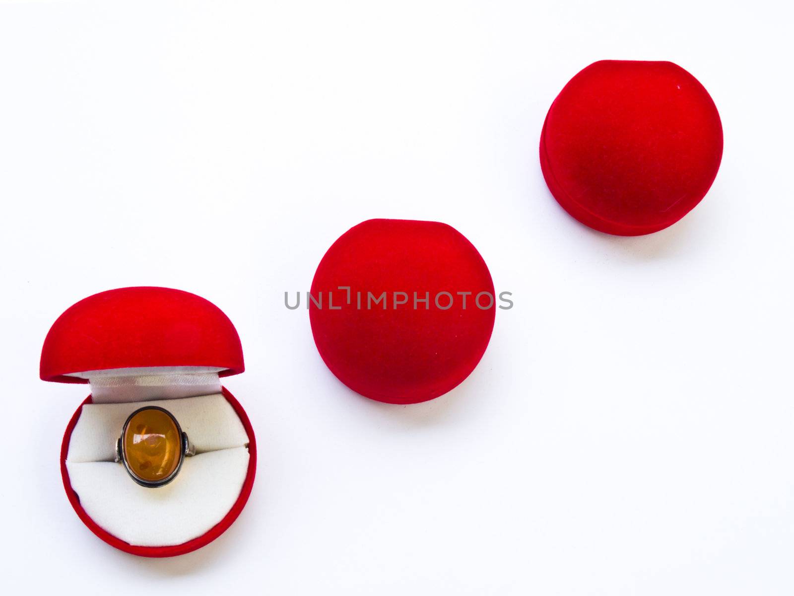 Opened round red jewelry boxes isolated on white background
