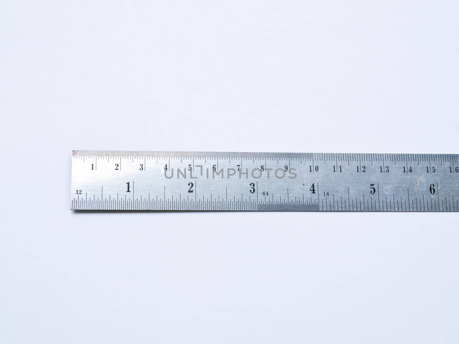 A used stainless steel ruler isolated on white background