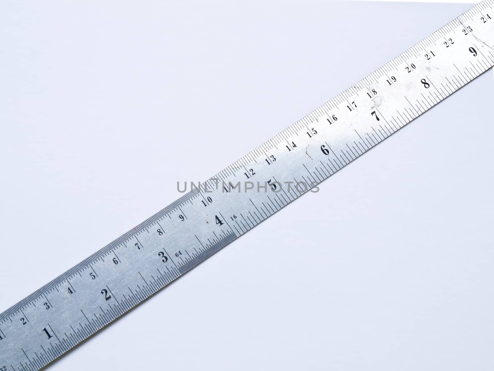 A used stainless steel ruler isolated on white background