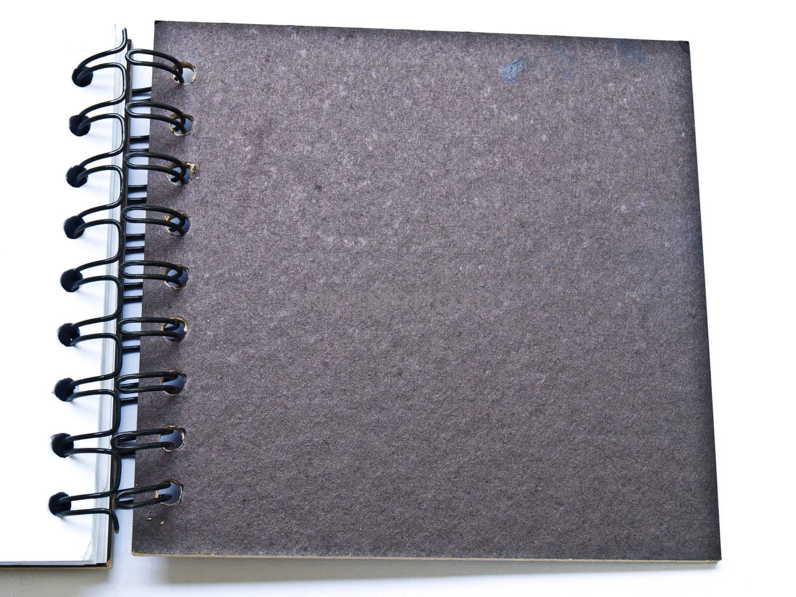 opened spiral binding notebook cover on white by gururugu