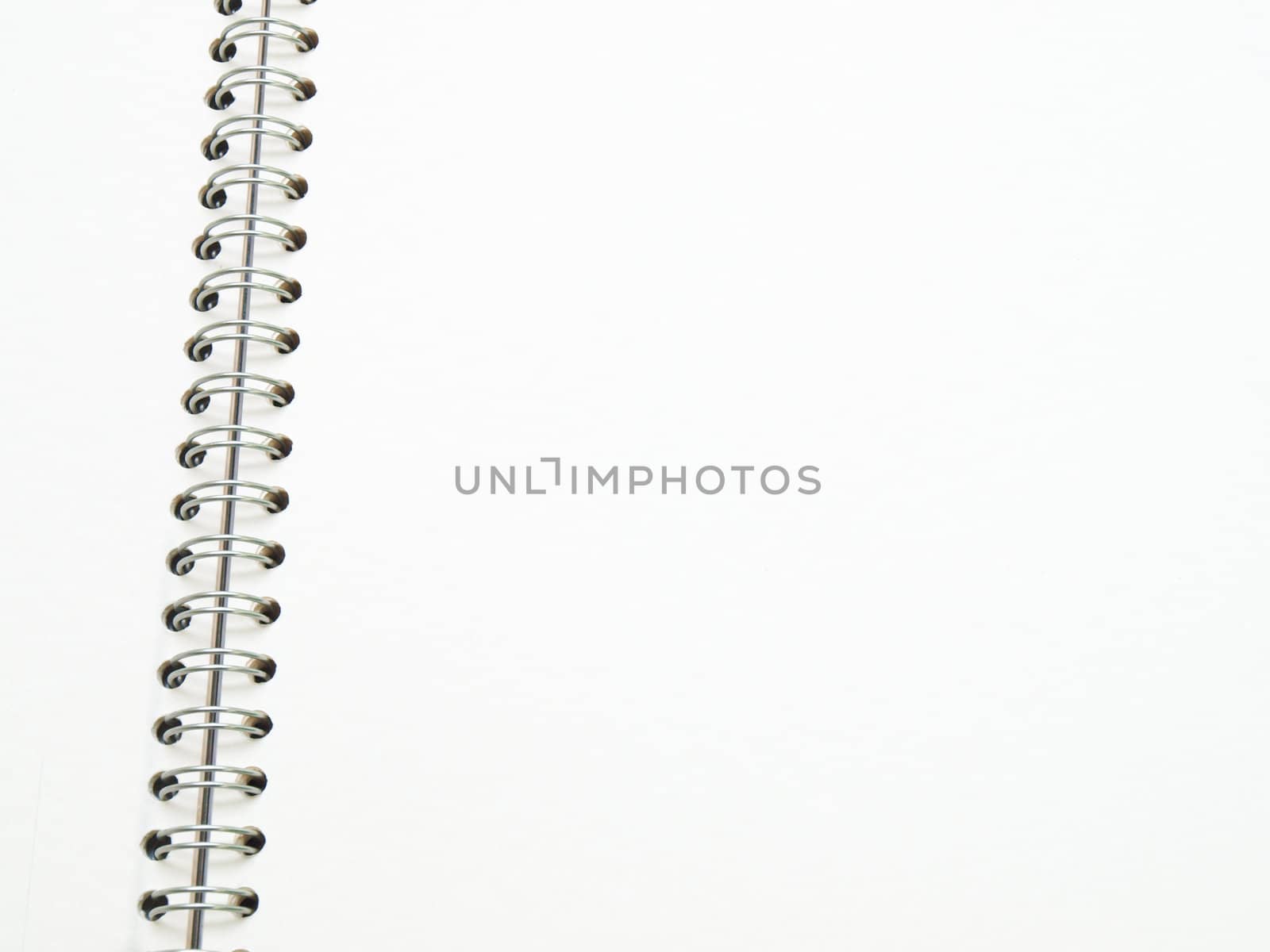 open spiral binding notebook on white by gururugu