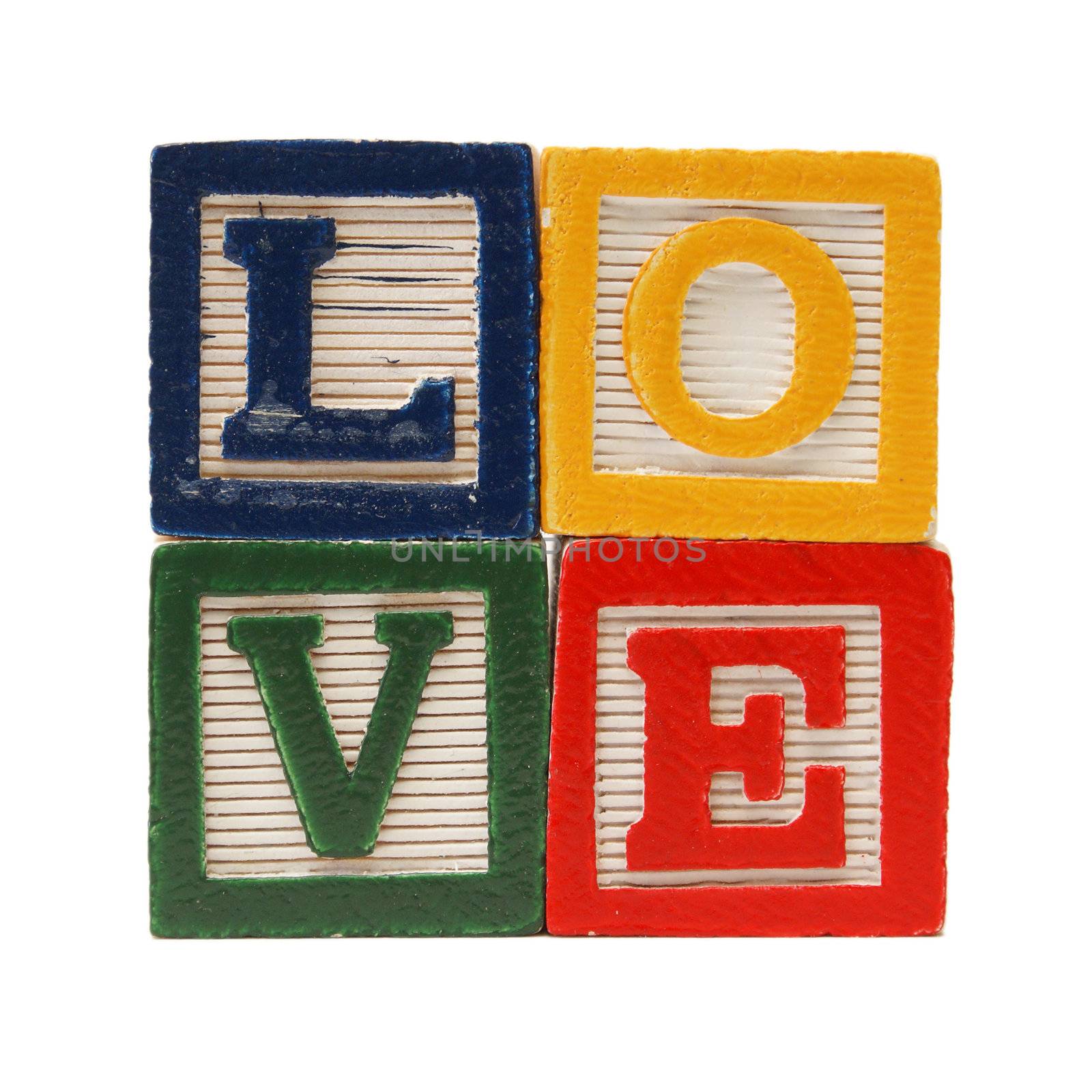 Alphabet blocks are used to create the word love in the shape of a square.