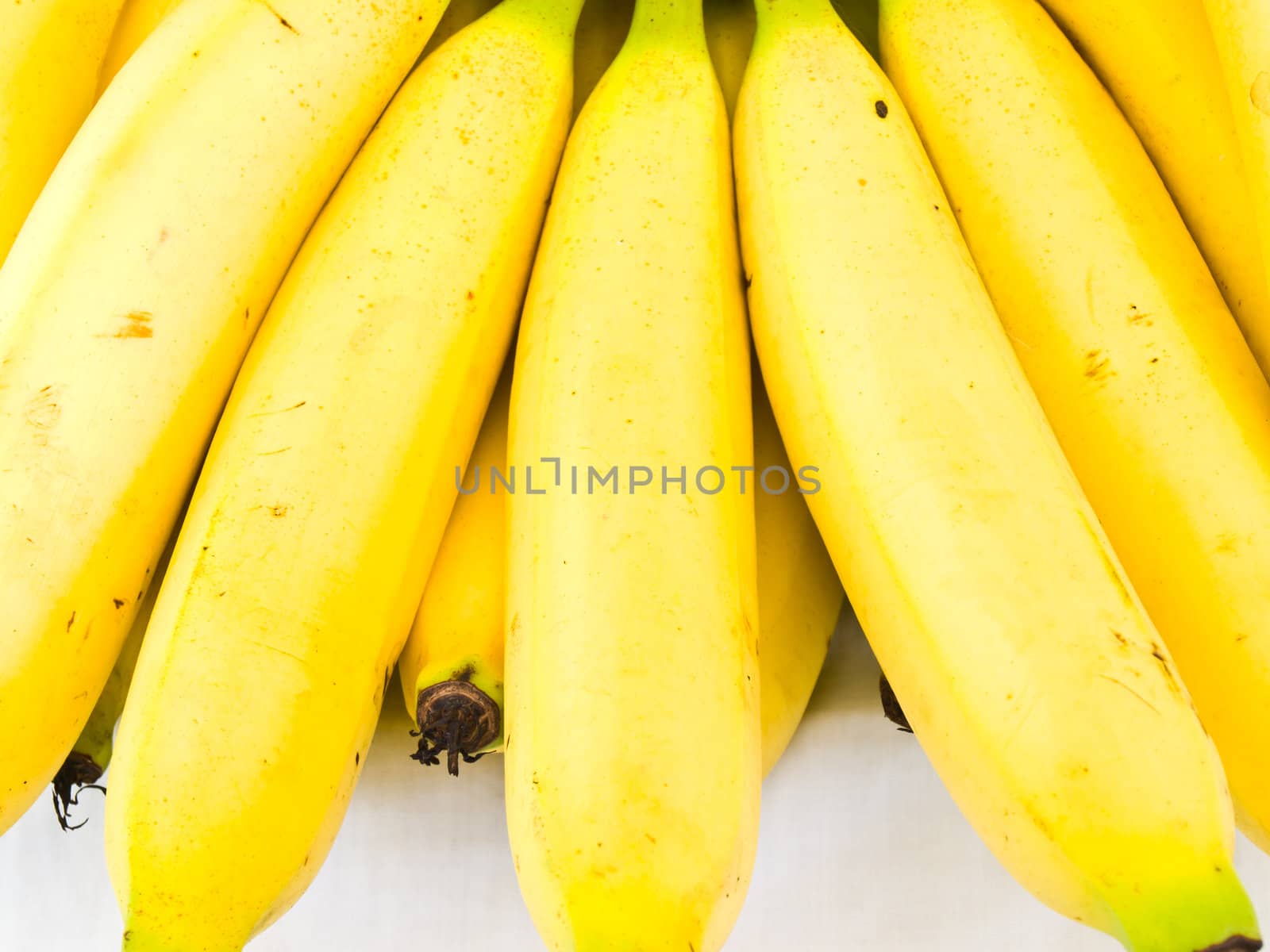 A bunch of ripe banansa isolated on white background by gururugu