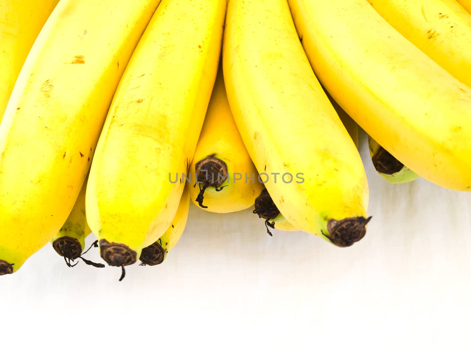 A bunch of ripe banansa isolated on white background by gururugu