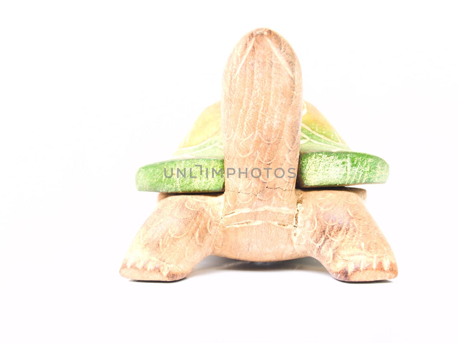A handicraft colorful wooden turtle in front view isolated on wh by gururugu