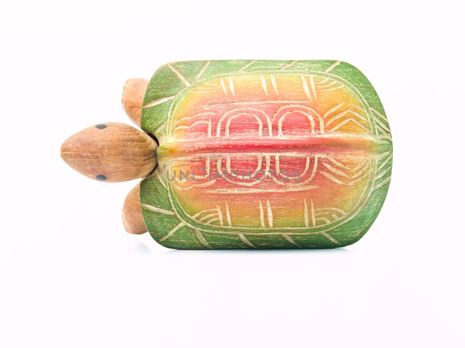 A handicraft colorful wooden turtle in top view isolated on whit by gururugu