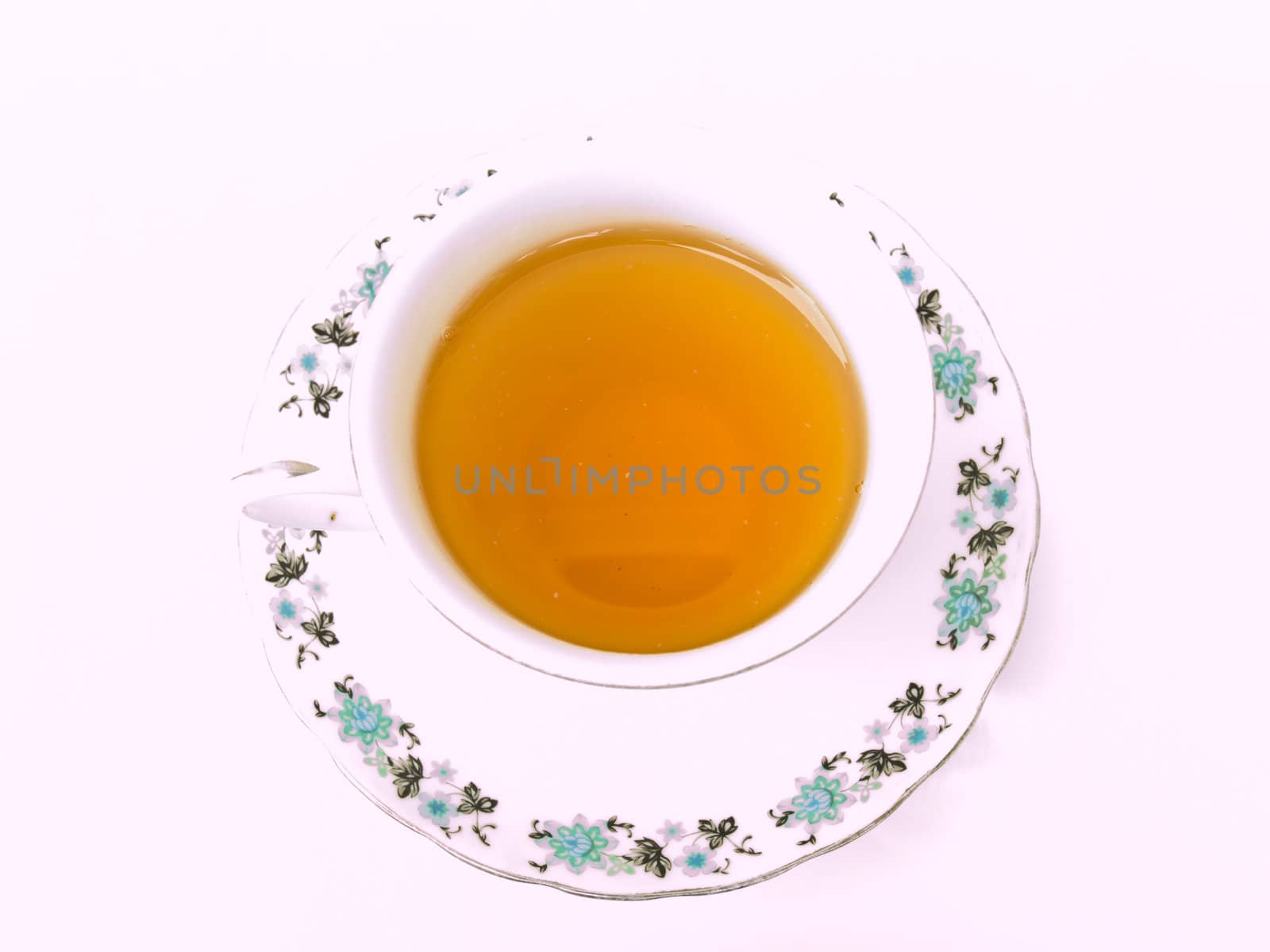 A cup of tea with floral pattern isolated on white background by gururugu