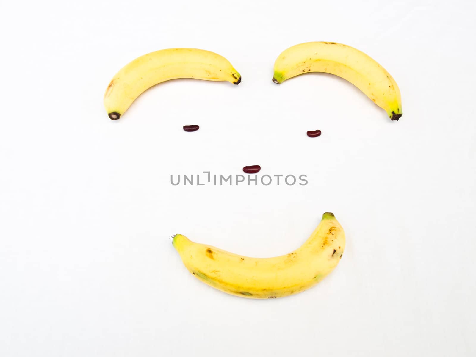 Smiling face made from banana and kidney bean Banana isolated on by gururugu